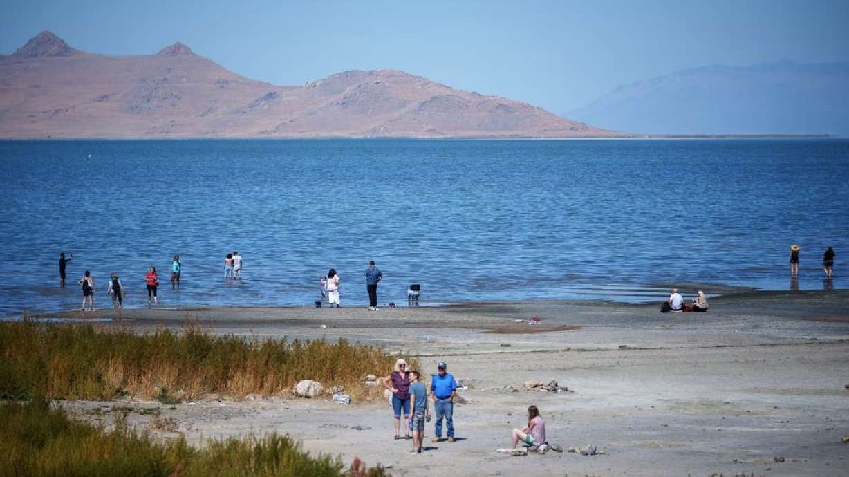 People on the shore of the Great Salt Lake on Sept. 16. Runoff filled reservoirs and knocked Utah out of drought status and water use only ticked up slightly.