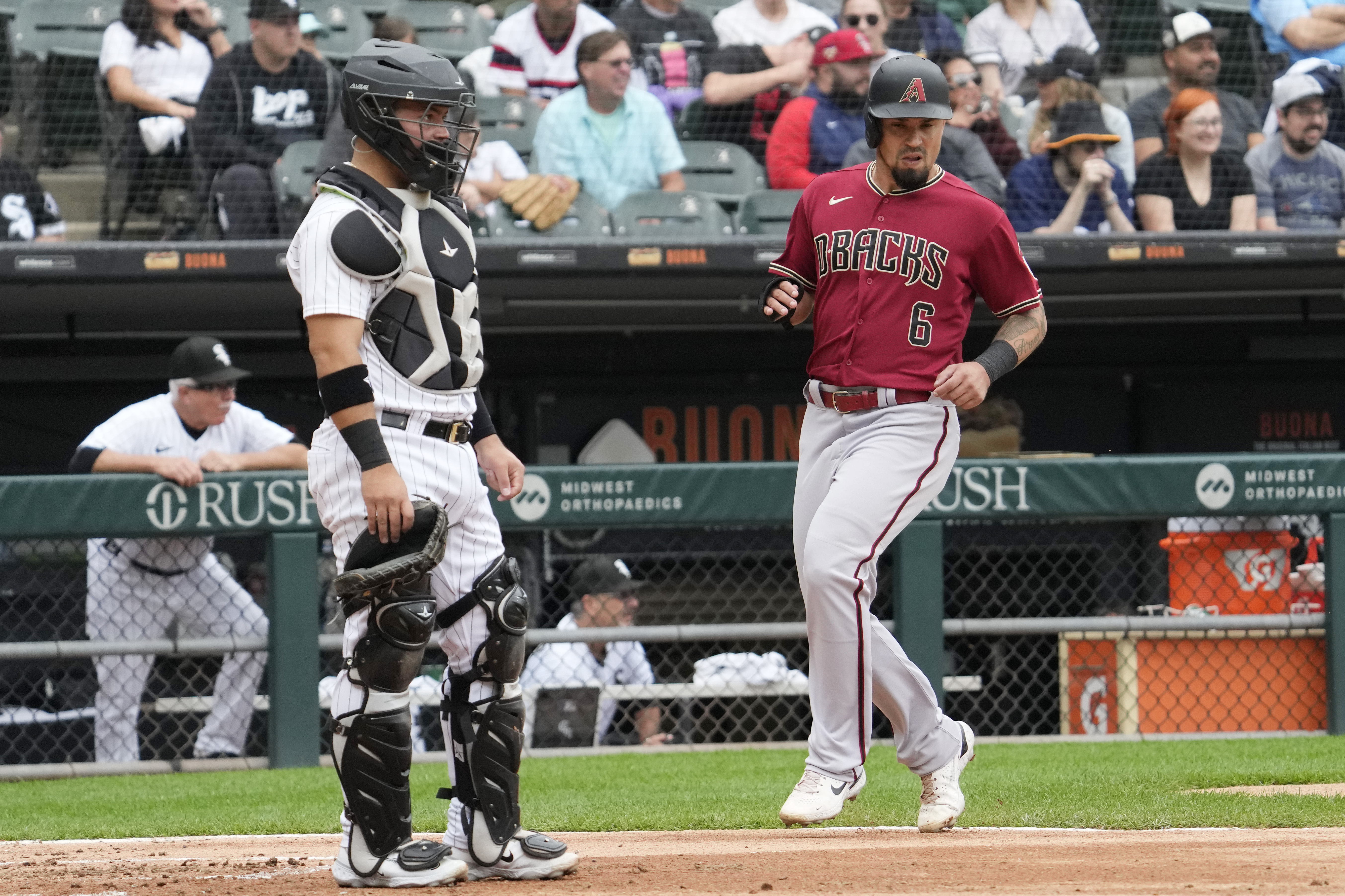 Arizona Diamondbacks' Jace Peterson, right, scores on a two-run double by Corbin Carroll as Chicago White Sox catcher Carlos Perez looks to the field during the third inning of a baseball game in Chicago, Wednesday, Sept. 27, 2023. 