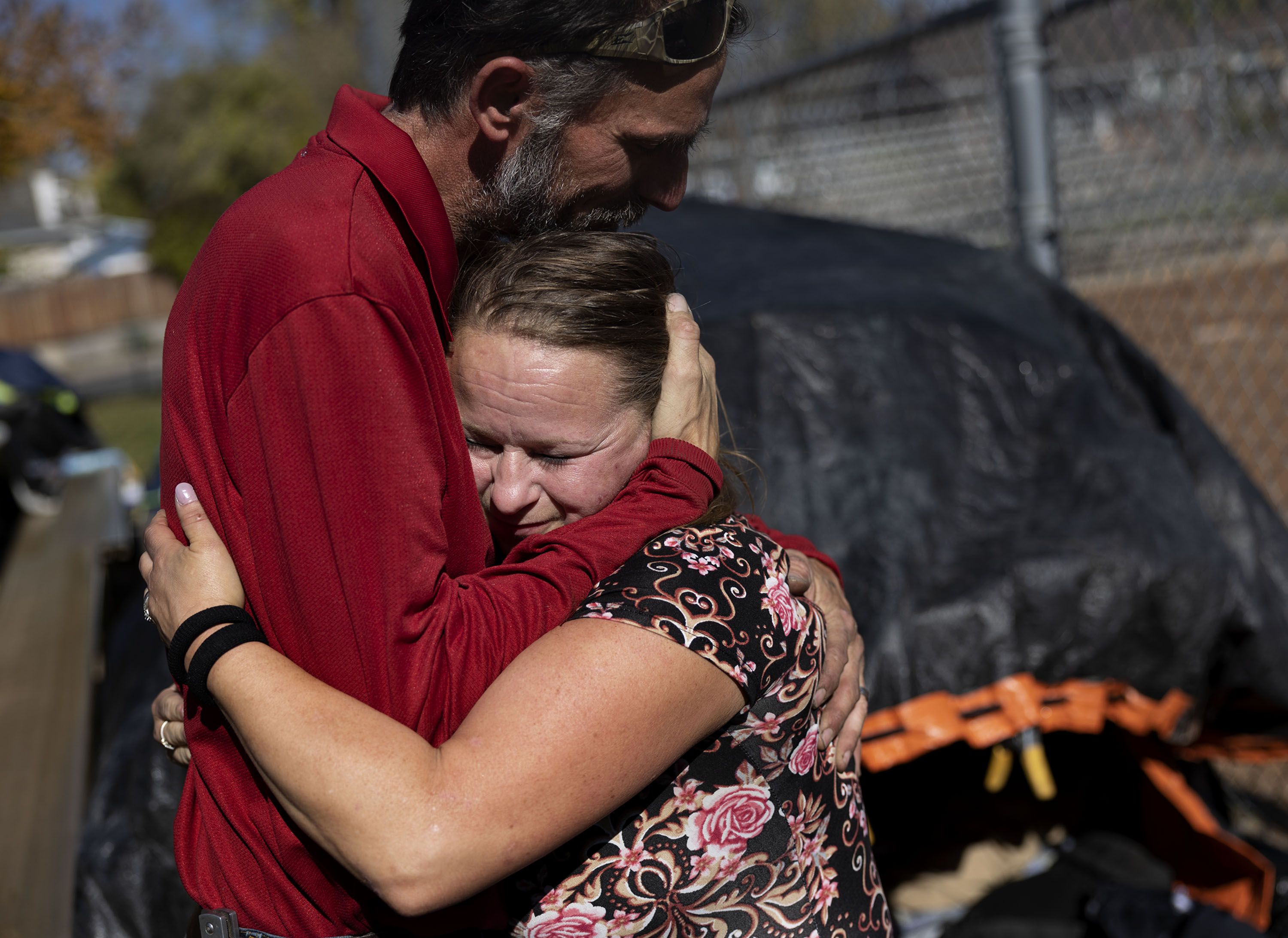 Julie Gommon and Doug Koogle hug while cleaning up their camp at Herman Franks Park in Salt Lake City on Friday. Both Gommon and Koogle said they would live in a sanctioned camp if possible. They need a place to safely store their belongings while at work.