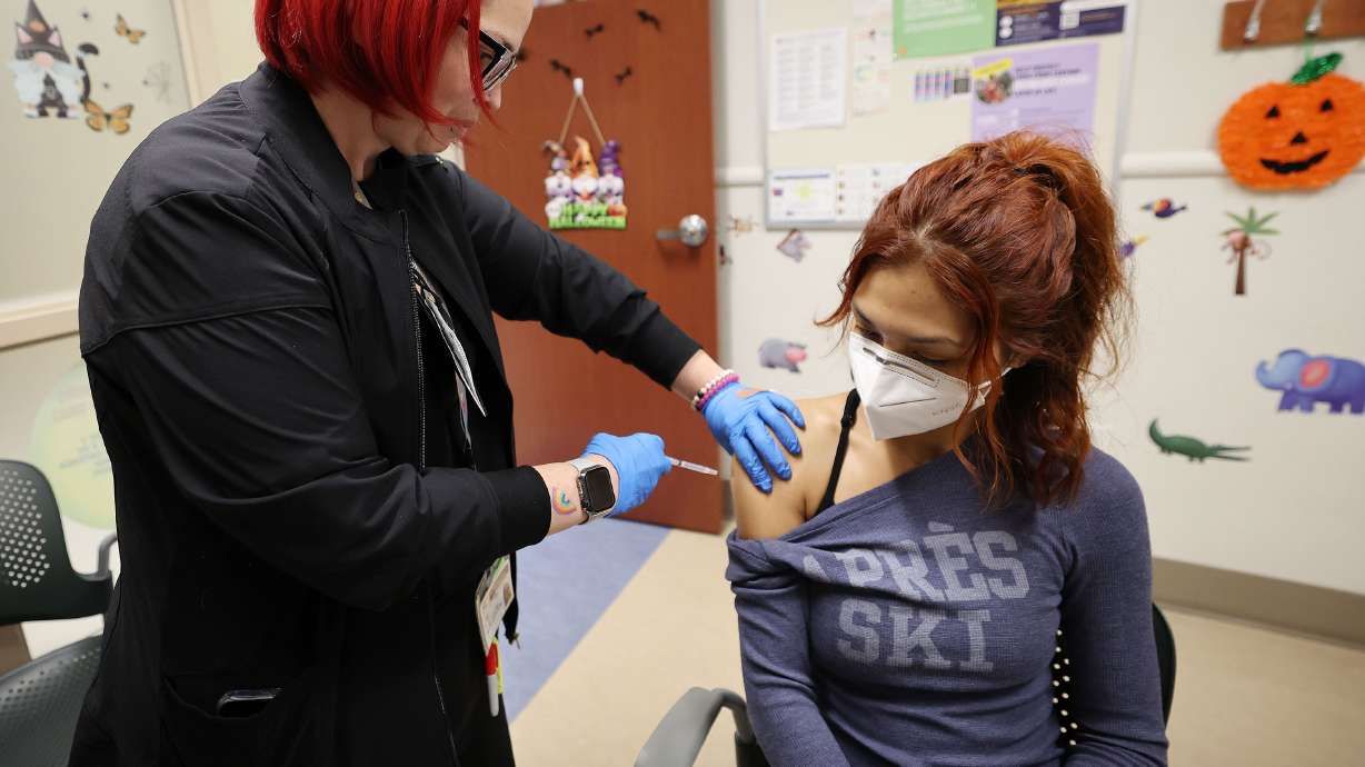 Angie Gonzales receives her COVID-19 vaccine from registered nurse Leila Callaway at Salt Lake County Health Center in Salt Lake City on Oct. 4. Fewer than 5% of all Utahns have received the latest COVID-19 shot.
