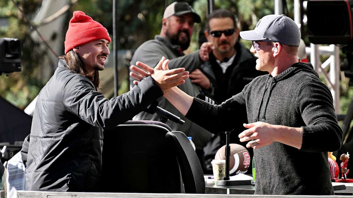 Utah quarterback Cam Rising greets AJ Hawk and others on the "Pat McAfee Show" at the University of Utah in Salt Lake City on Friday, Oct. 27, 2023.