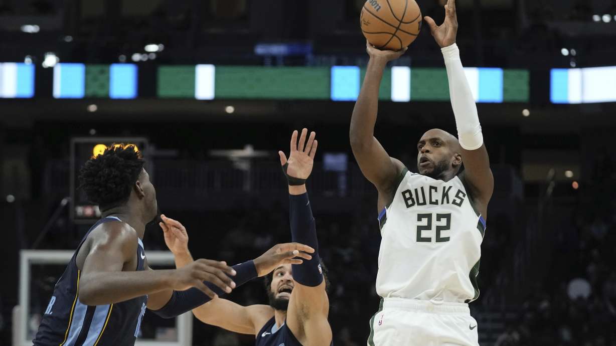 Milwaukee Bucks' Khris Middleton shoots past Memphis Grizzlies' David Roddy during the first half of a preseason NBA basketball game Friday, Oct. 20, 2023, in Milwaukee.