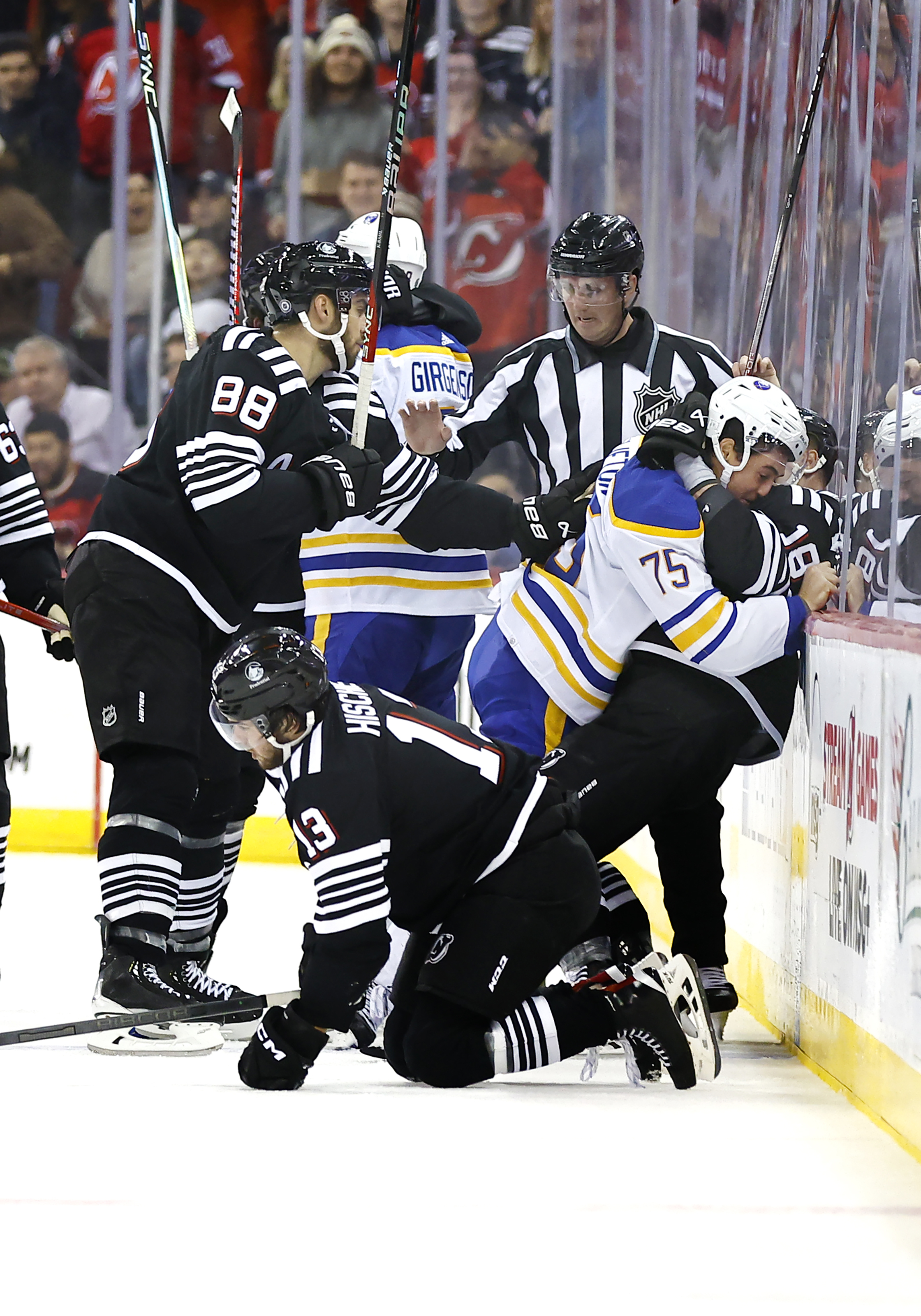 Buffalo Sabres defenseman Connor Clifton (75) and New Jersey Devils left wing Ondrej Palat (18) fight during the first period of an NHL hockey game Friday, Oct. 27, 2023, in Newark, N.J. 