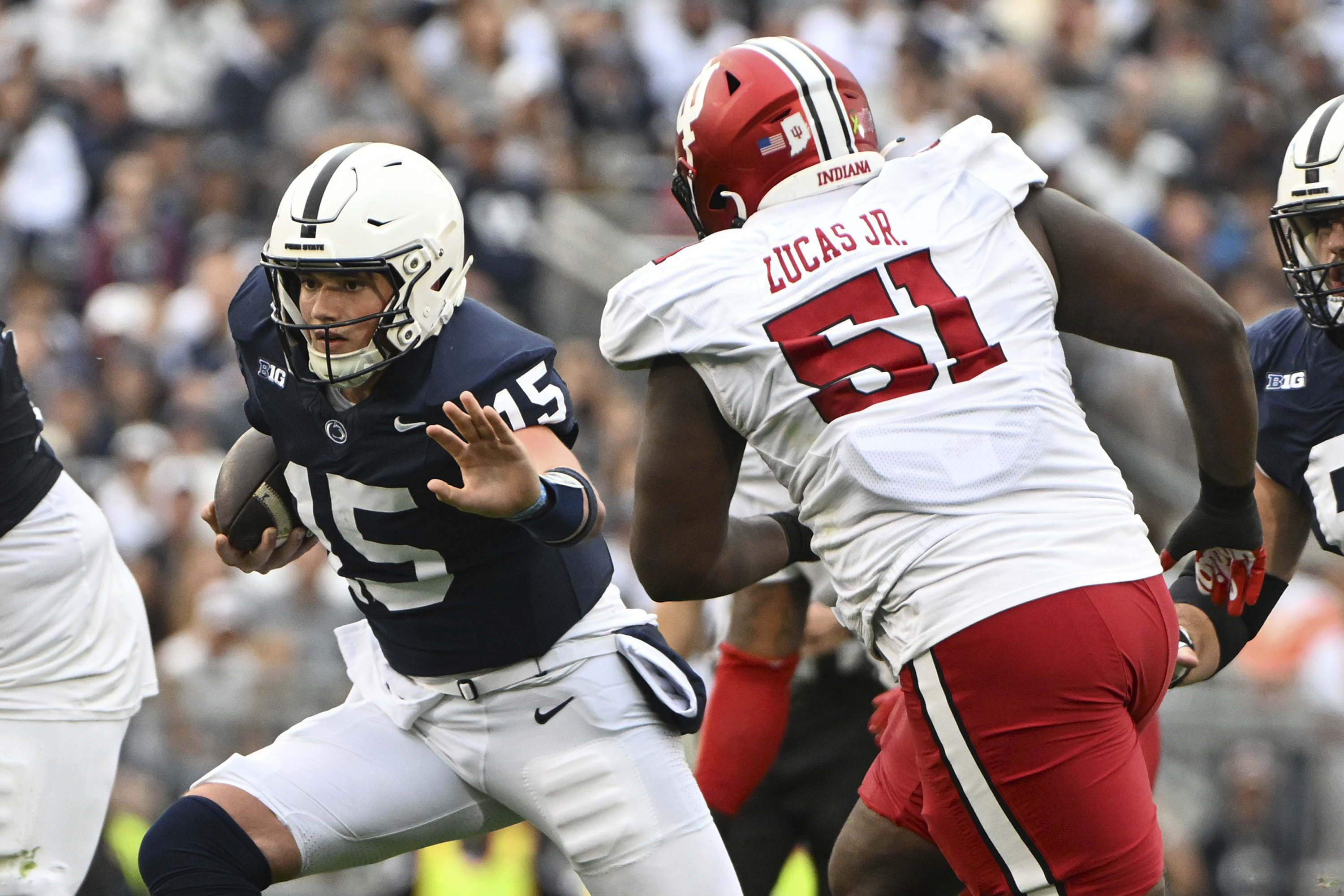 Penn State quarterback Drew Allar (15) looks to elude Indiana defensive lineman Patrick Lucas Jr. (51) during the first half of an NCAA college football game, Saturday, Oct. 28, 2023, in State College, Pa. 
