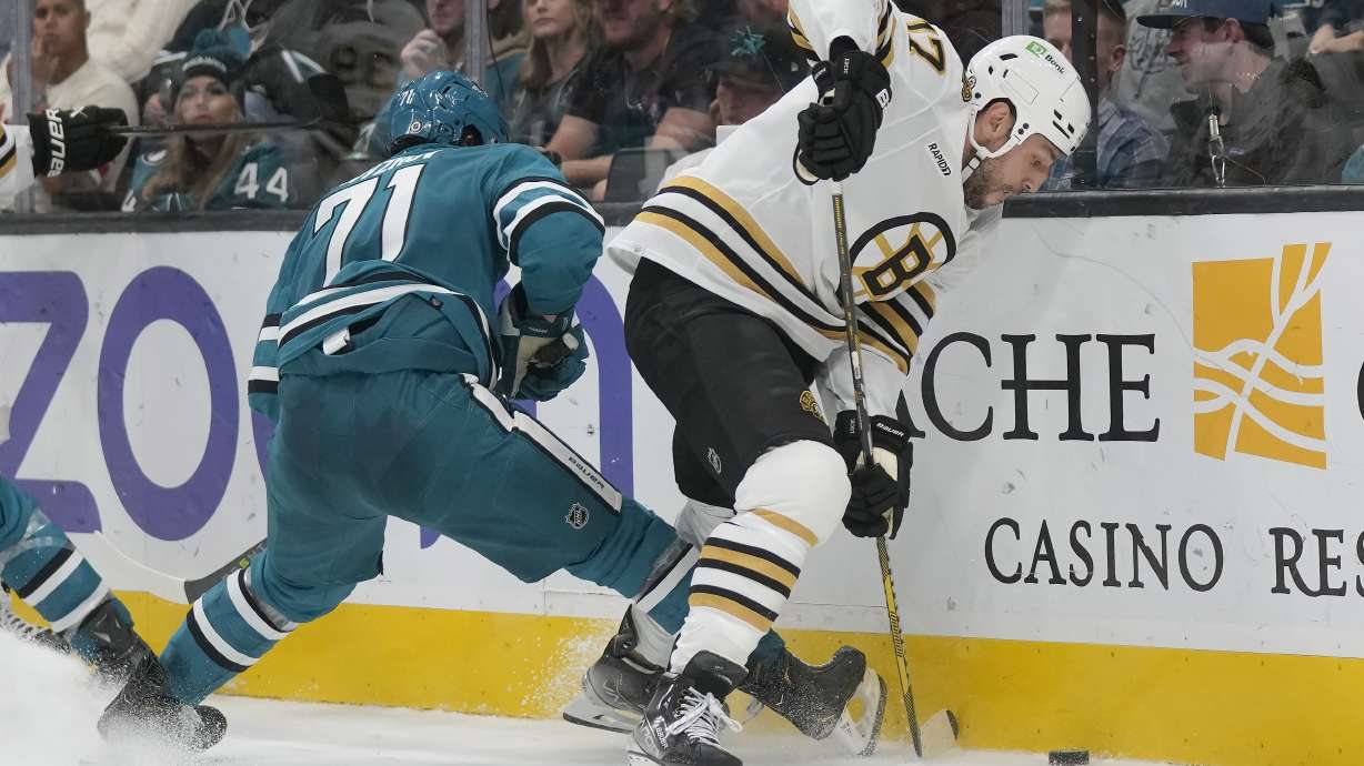 Boston Bruins left wing Milan Lucic (17) reaches for the puck in front of San Jose Sharks defenseman Nikolai Knyzhov (71) during the second period of an NHL hockey game in San Jose, Calif., Thursday, Oct. 19, 2023.
