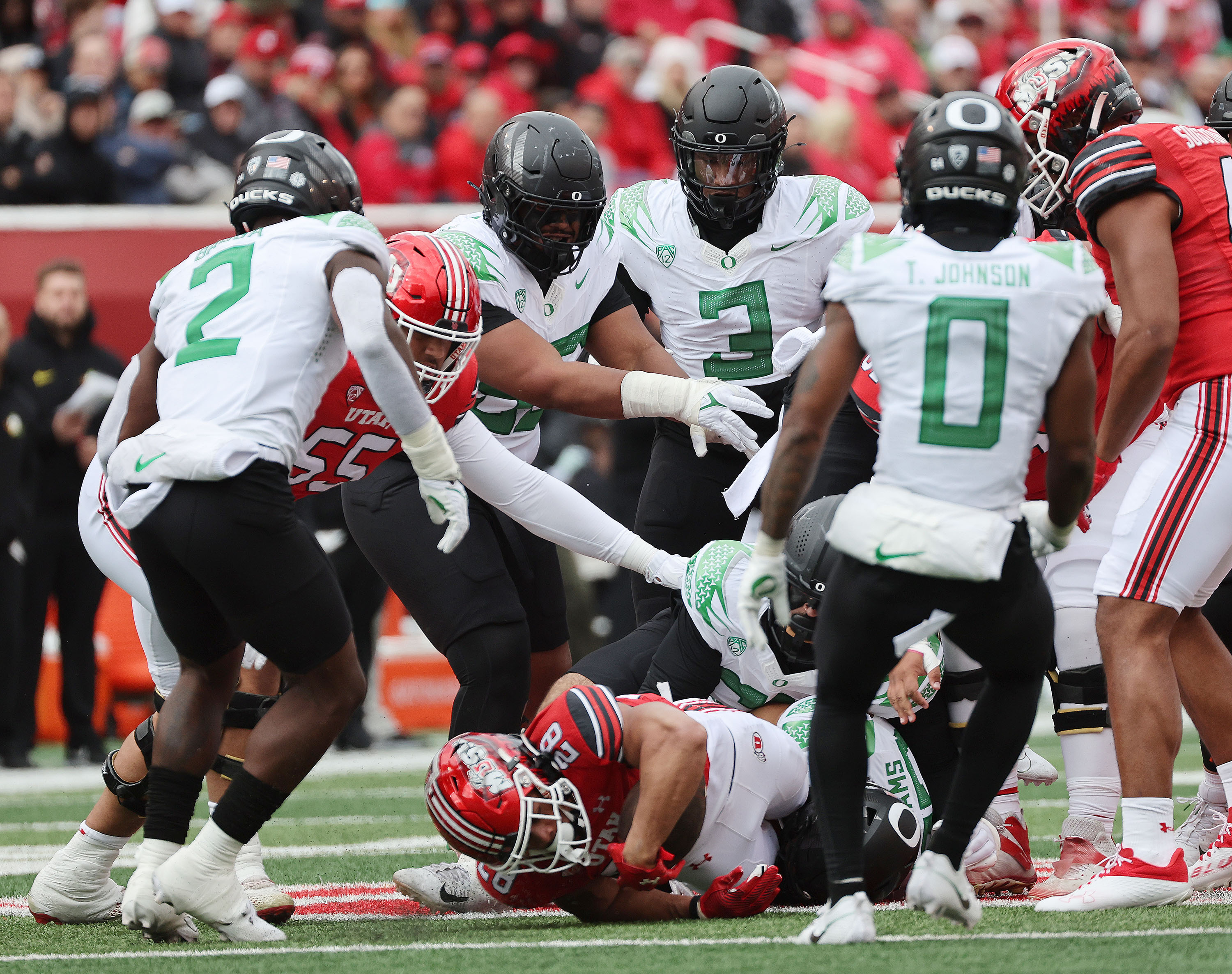Utah Utes runner Sione Vaki (28) is surrounded by Oregon defenders in Salt Lake City on Saturday, Oct. 28, 2023. Oregon won 35-6.