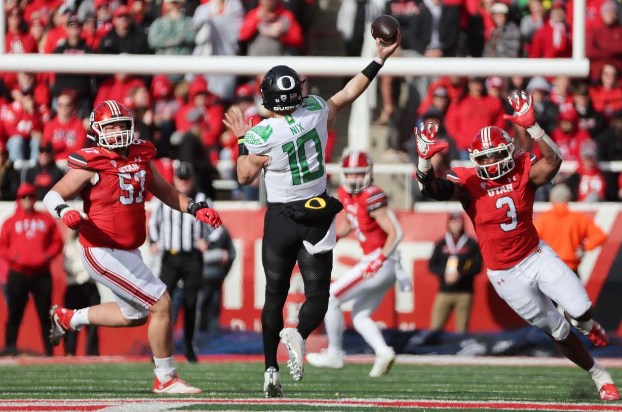 Utah Utes defensive tackle Keanu Tanuvasa (57) and Utah Utes linebacker Levani Damuni (3) hurry Oregon Ducks quarterback Bo Nix (10) in Salt Lake City on Saturday, Oct. 28, 2023. Oregon won 35-6.