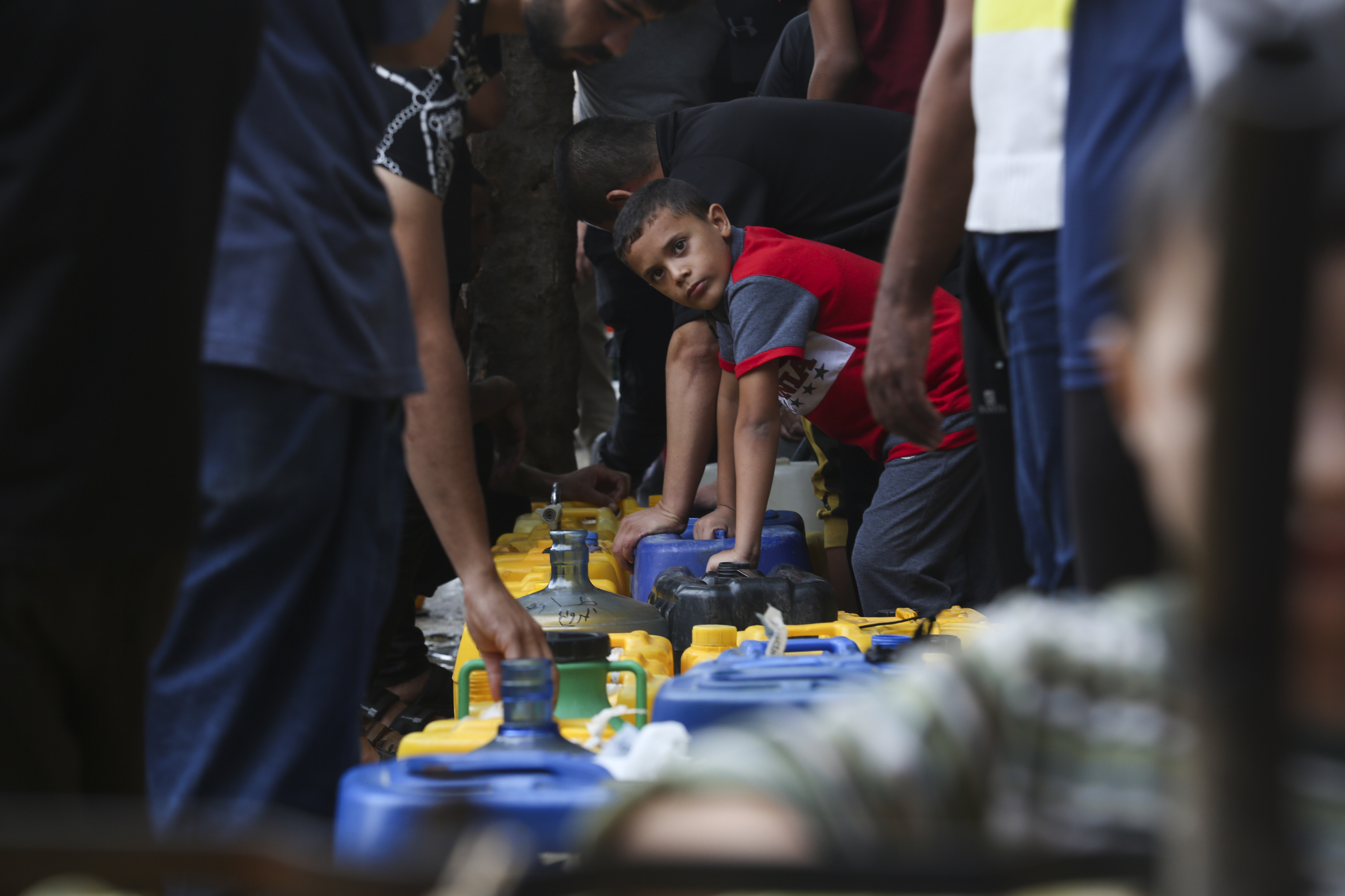 Palestinians arrive to collect drinking water during the ongoing Israeli bombardment of the Gaza Strip in Rafah on Saturday. As Israel moves into the second phase of its offensive in Gaza, Utahns are divided on whether the United States is doing enough as one of its closest allies defends itself against Hamas.