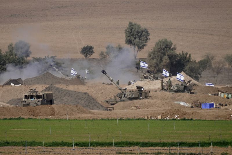 An Israeli mobile artillery unit is seen in a position near the Israel-Gaza border, Israel, Saturday. Israel on Saturday expanded its ground operation in Gaza with infantry and armored vehicles backed by "massive" strikes from the air and sea, including the bombing of Hamas tunnels, a key target in its campaign to crush the territory's ruling group after its bloody incursion in Israel three weeks ago.