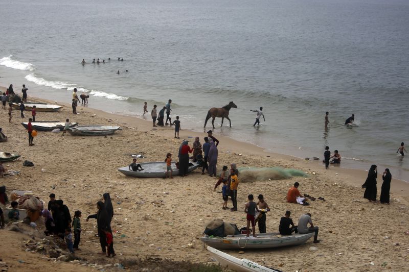 Palestinians resort to the sea water to bathe and clean their tools and clothes due the continuing water shortage in the Gaza Strip, on the beach of Deir al-Balah, Central Gaza Strip, Sunday.