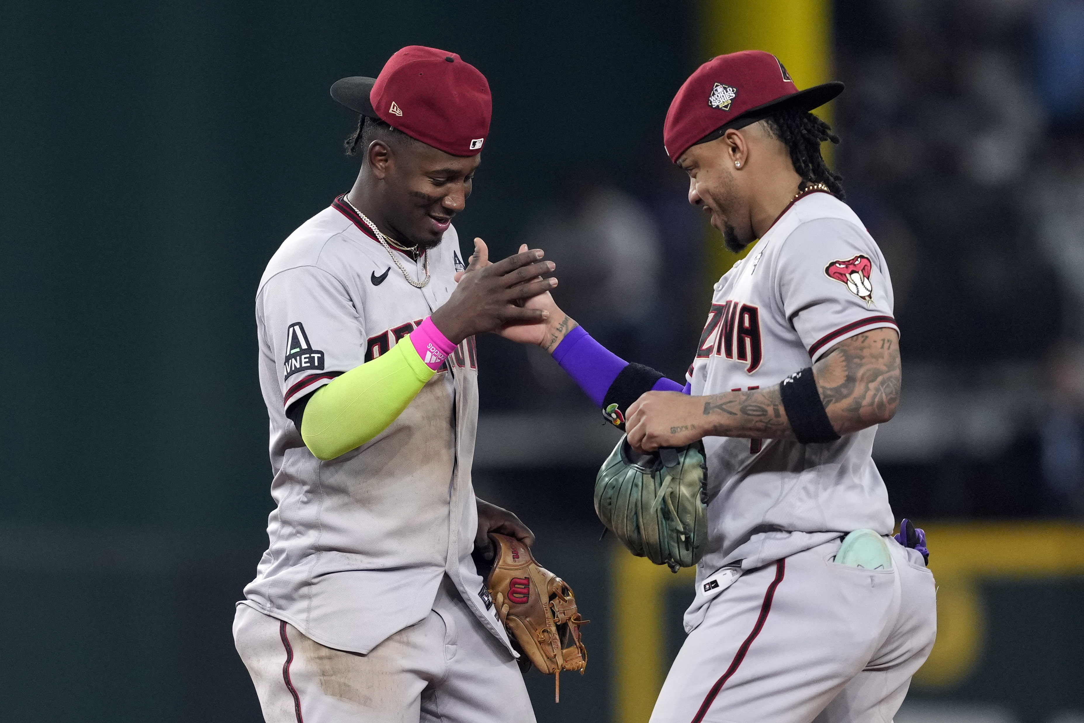 Arizona Diamondbacks' Geraldo Perdomo, left, and Ketel Marte celebrate after Game 2 of the baseball World Series against the Texas Rangers Saturday, Oct. 28, 2023, in Arlington, Texas. The Diamondbacks won 9-1. 