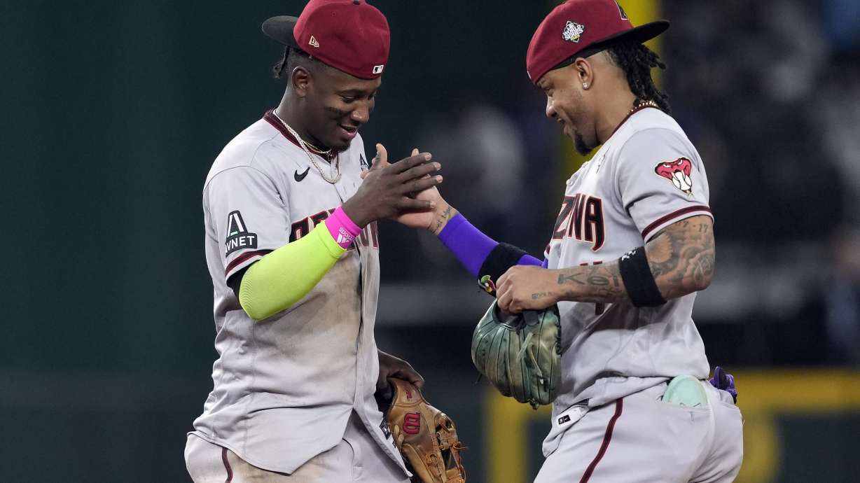 Arizona Diamondbacks' Geraldo Perdomo, left, and Ketel Marte celebrate after Game 2 of the baseball World Series against the Texas Rangers Saturday, Oct. 28, 2023, in Arlington, Texas. The Diamondbacks won 9-1.