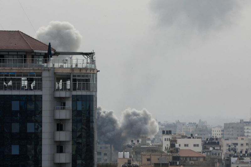 Plumes of smoke rise during Israeli strikes, amid the ongoing conflict between Israel and Palestinian Islamist group Hamas, in Gaza City, Sunday. Armored Israeli forces attacked the Gaza Strip's main city from two directions on Monday.