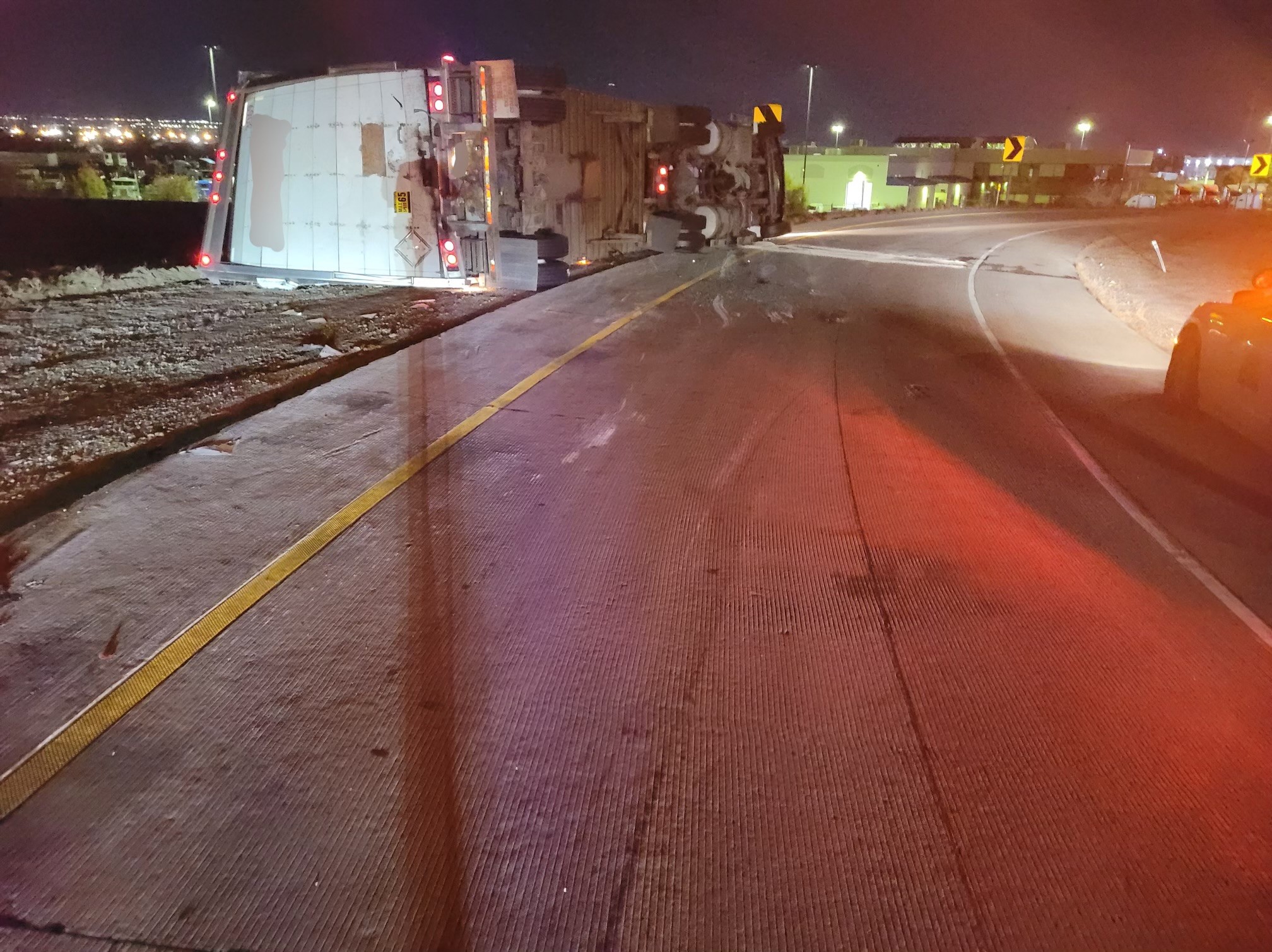 A semitruck is pictured after a crash on the ramp to eastbound state Route 201 from southbound I-215 West in West Valley City, Monday.