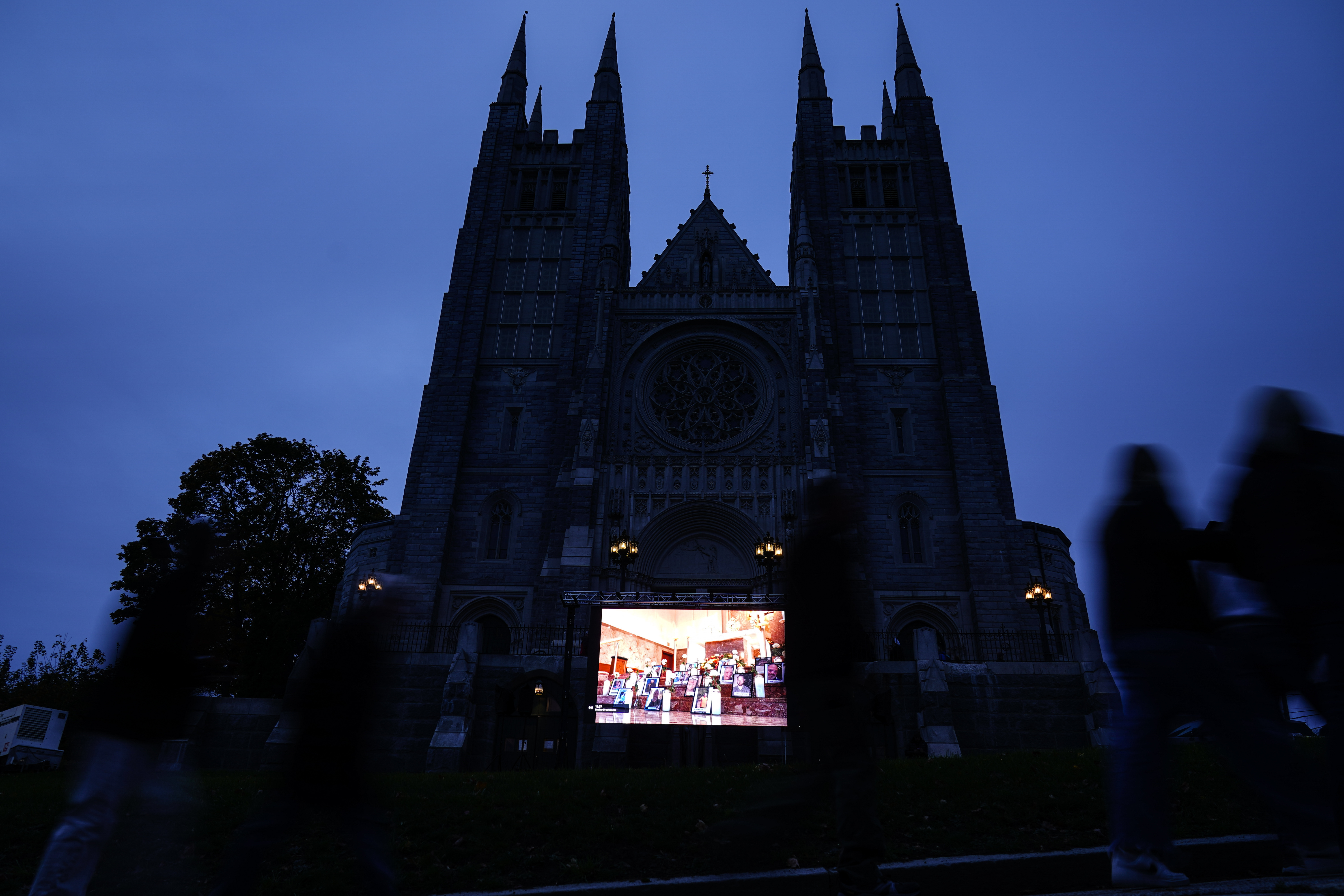 A video screen is set up Sunday, outside the Basilica of Saints Peter and Paul in Lewiston, Maine, ahead of a vigil for the victims of Wednesday's mass shootings.