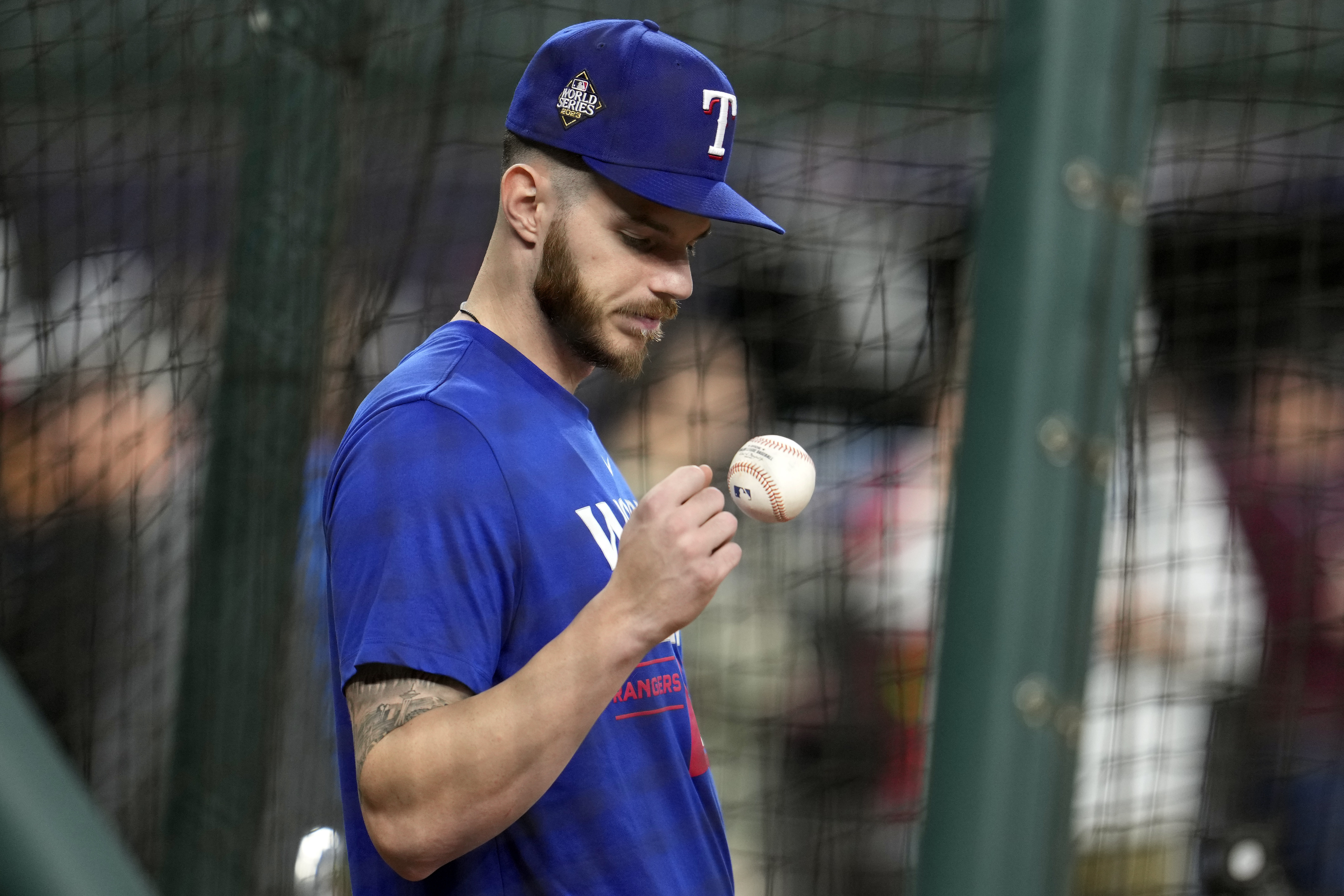 Texas Rangers catcher Jonah Heim tosses a ball during batting practice before Game 2 of the baseball World Series against the Arizona Diamondbacks Saturday, Oct. 28, 2023, in Arlington, Texas. 