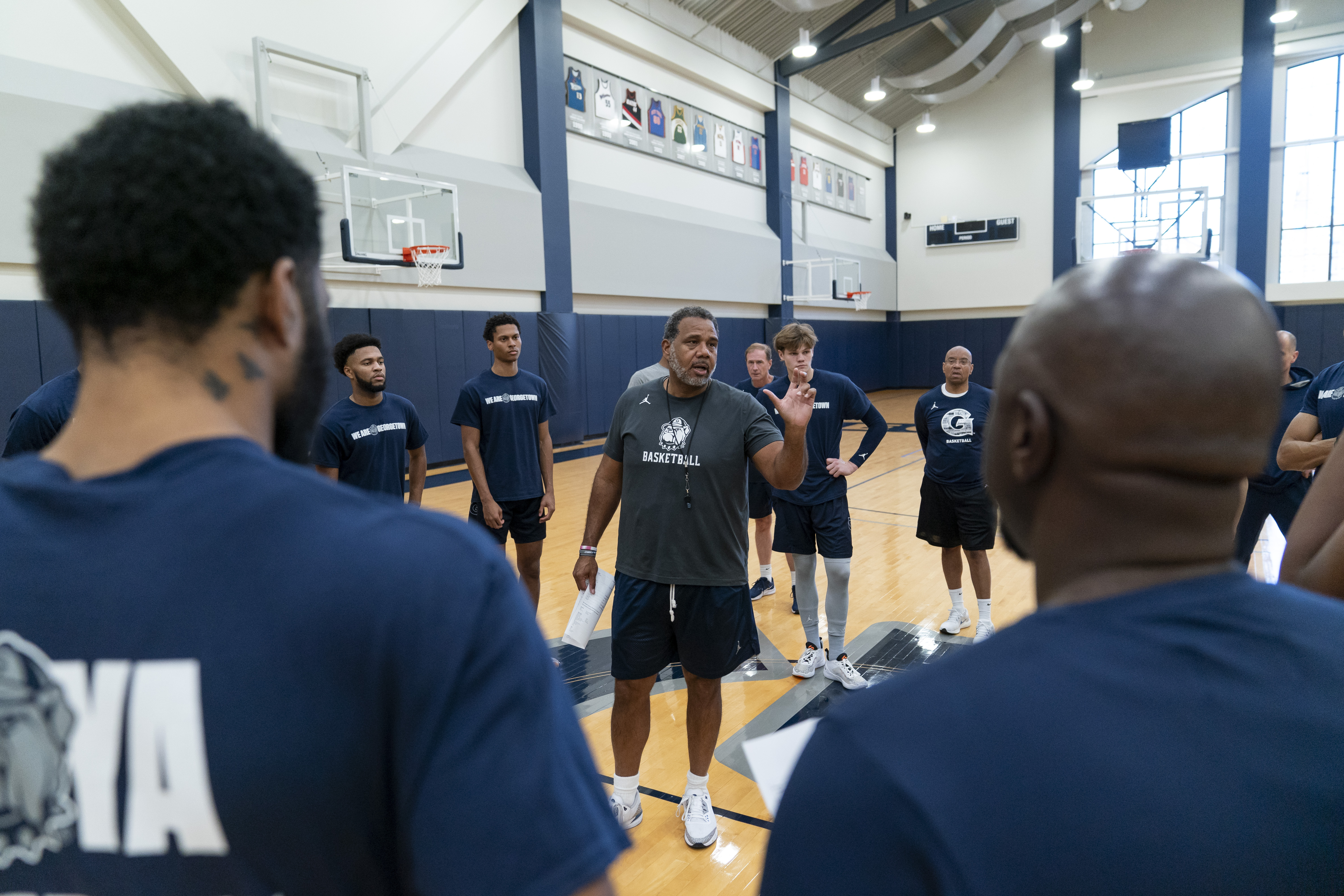 Georgetown head coach Ed Cooley, center, speaks to players before the start of an NCAA college basketball practice Thursday, Oct. 19, 2023, in Washington. 