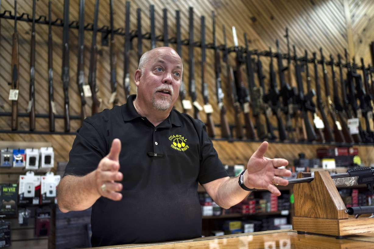 Rick LaChapelle, owner of Coastal Trading and Pawn, is seen at the counter of his gun shop in Auburn, Maine, in this July 18, 2022, photo. LaChapelle's staff declined to release a gun suppressor in August to Robert Card, the man authorities have identified as the gunman in the shooting that left 18 dead in Lewiston.