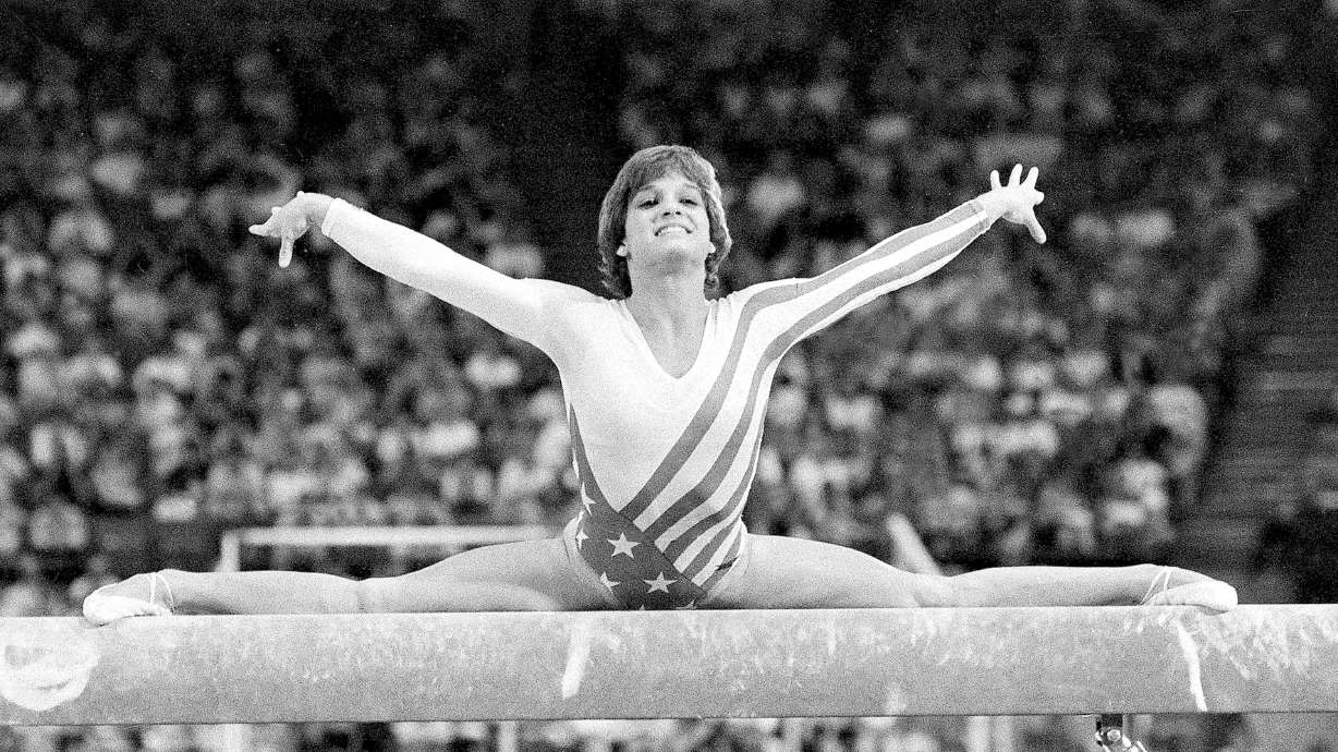 FILE - Mary Lou Retton, of the United States, performs on the balance beam during the women's gymnastics individual all-around finals at the Summer Olympics on Aug. 3, 1984, in Los Angeles. Retton. 55, is in intensive care in a Texas hospital fighting a rare form of pneumonia, according to her daughter McKenna Kelley.