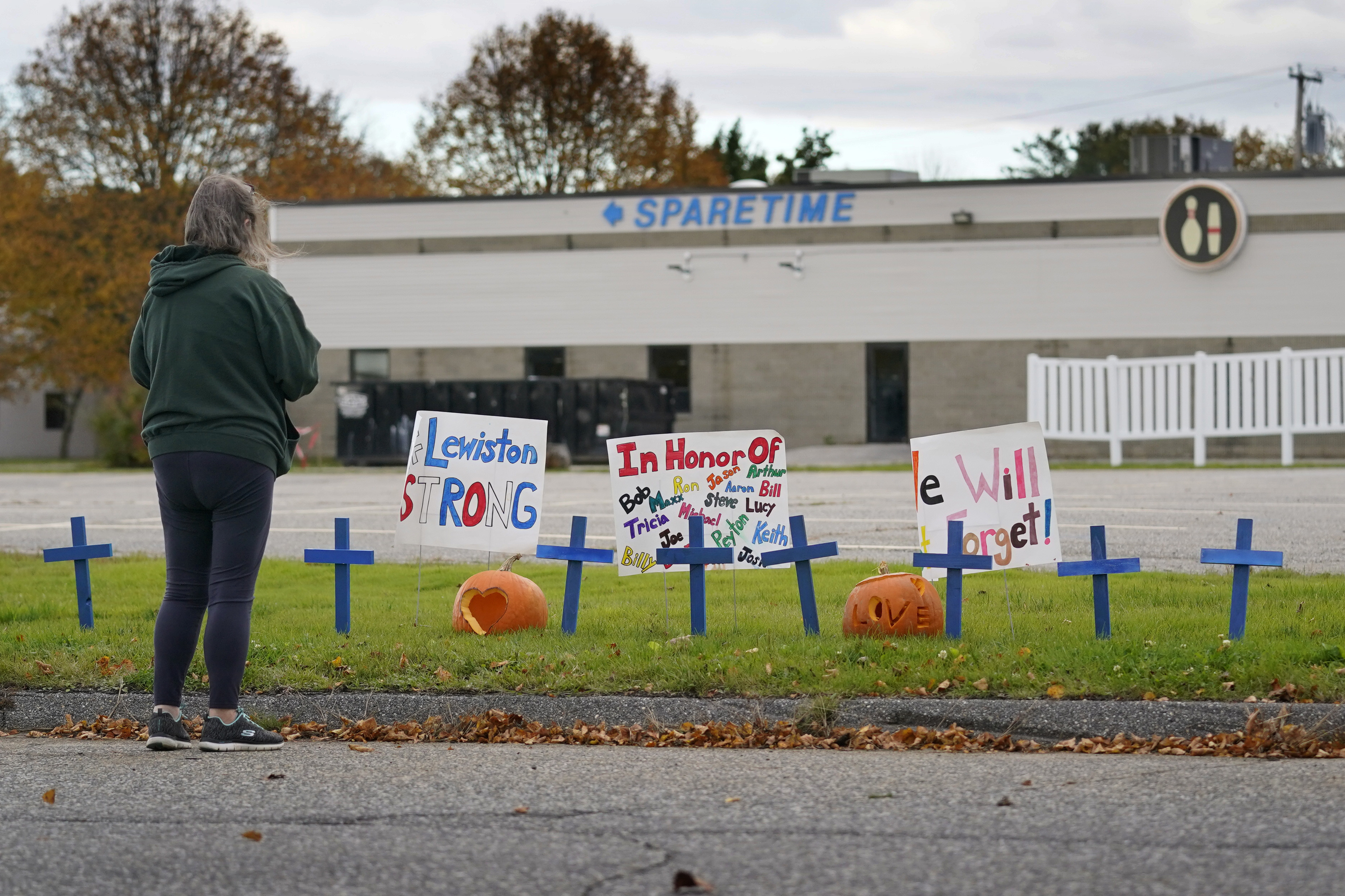 A makeshift memorial outside Sparetime Bowling Alley, one of this week's mass shooting sites, in Lewiston, Maine. The shooter's family expressed concerns about his deteriorating mental health months before the rampage.