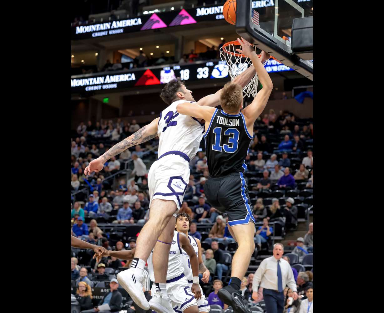 Westminster forward Gabriel Oliviera (32) fouls BYU guard Tanner Toolson (13) at the hoop during the game at Vivint Arena in Salt Lake City on Tuesday, Nov. 29, 2022.
