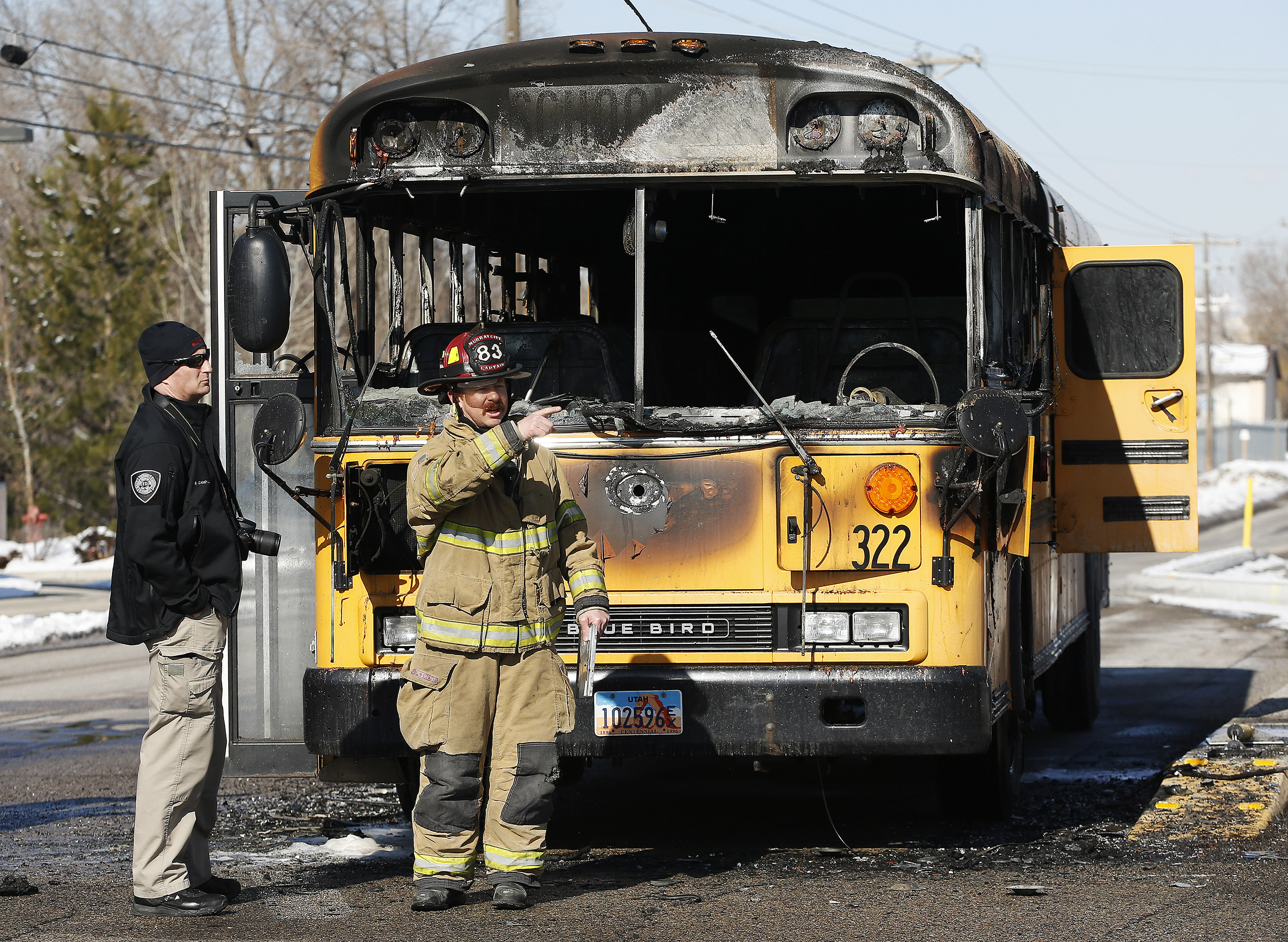 A Granite School District bus is looked over after it caught fire on Jan. 27, 2017. No students were on board. The man driving the bus that day was arrested Monday and linked to four school bus fires over the past few years, according to police.