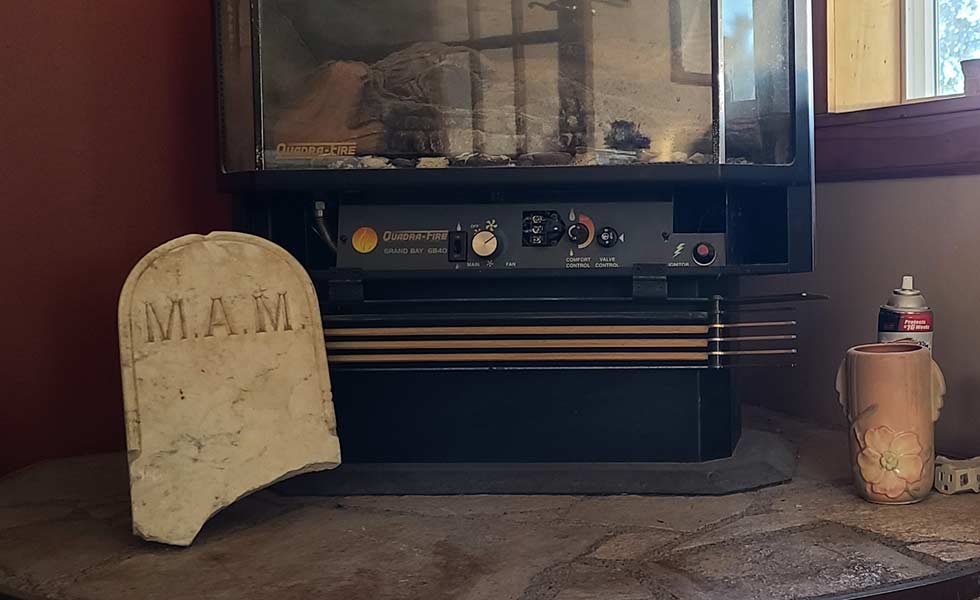 The alleged tombstone for Michael A. Mooney is placed below Palmer’s fireplace.