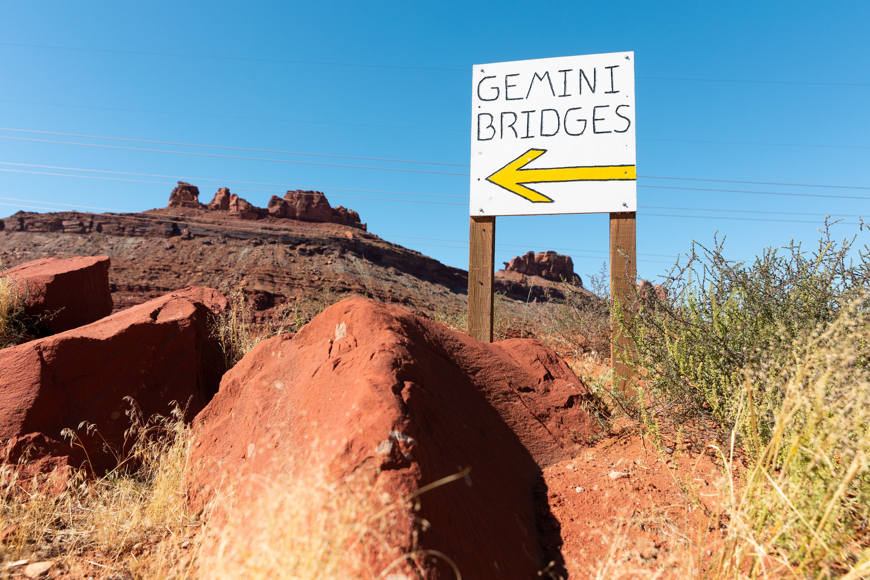 A sign points to Gemini Bridges on Sept. 22, 2023. The Bureau of Land Management said Wednesday it will review its 2023 travel management area for the area and Labyrinth Canyon near Moab, rekindling a debate over how the land is used.