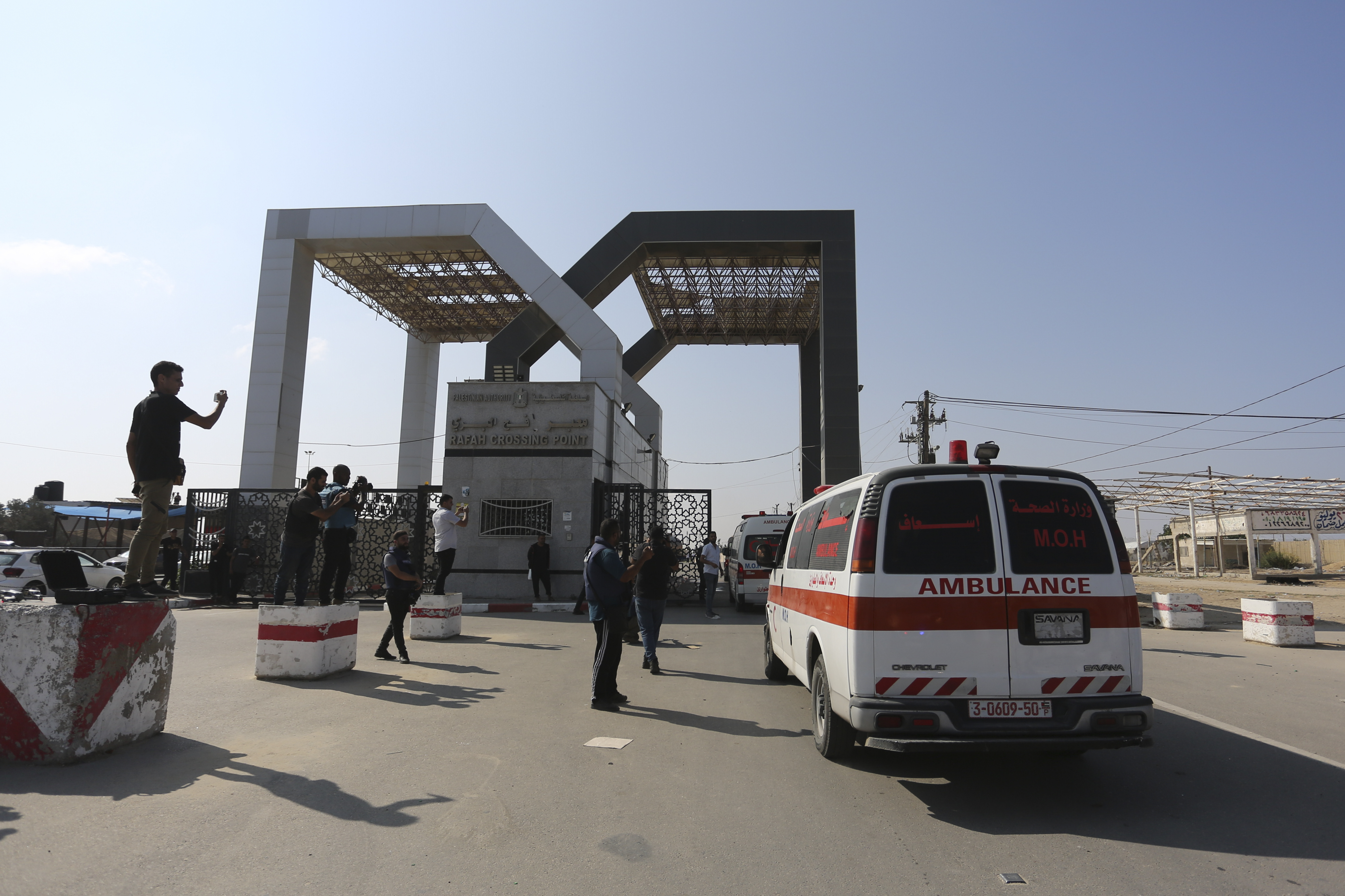 Palestinian ambulances with people wounded in the Israeli bombing of the Gaza Strip arrive at the border crossing with Egypt on Wednesday.