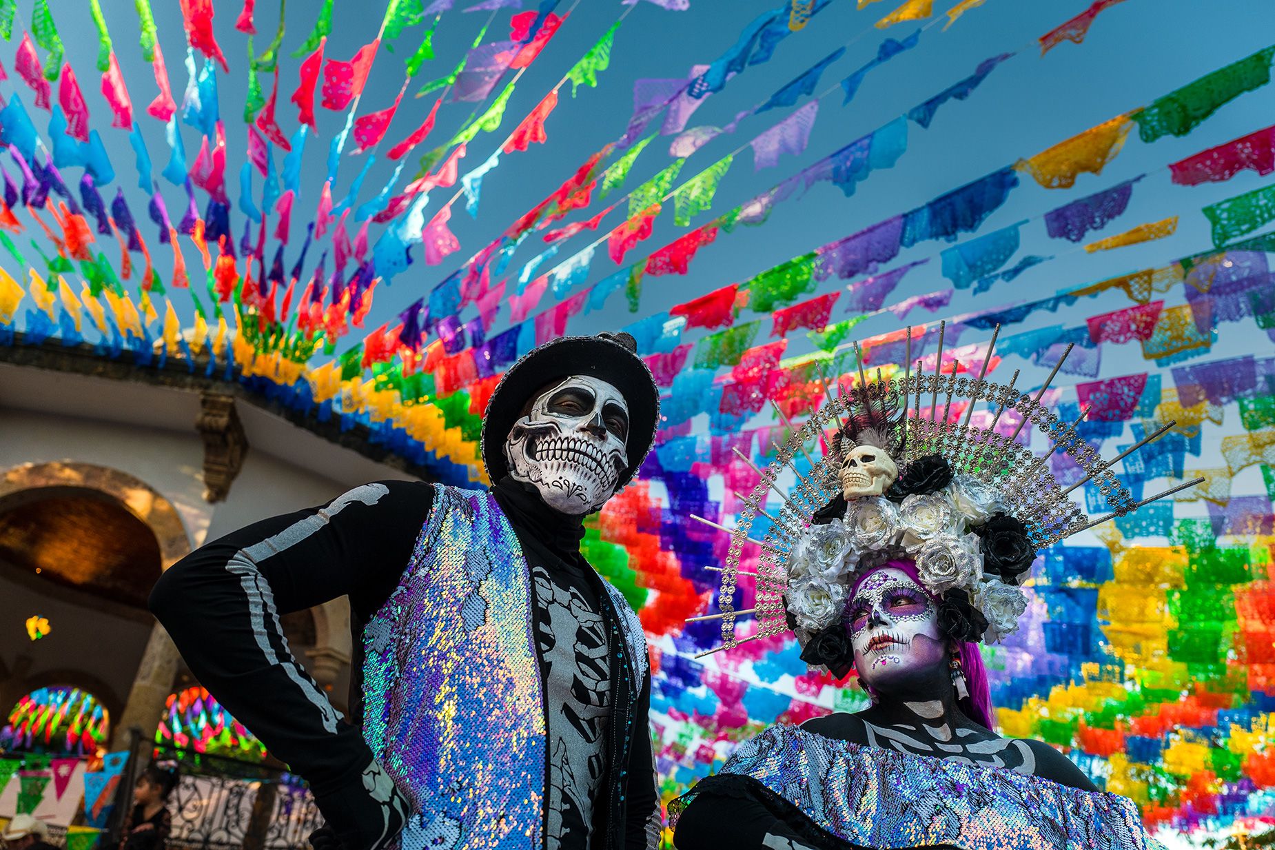 A young woman, dressed as La Catrina, and a young man, dressed as Catrin, particpate in the Day of the Dead festivities on Oct. 31, 2022 in Jalisco, Mexico.
	