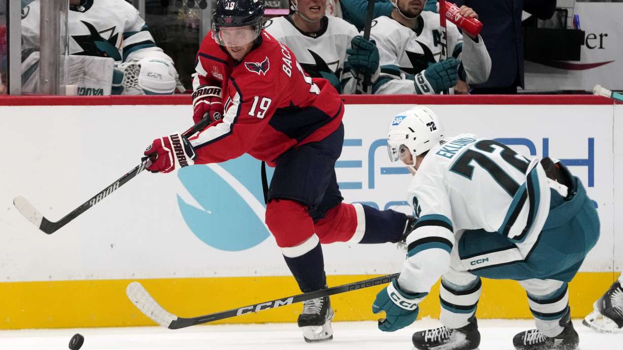 Washington Capitals center Nicklas Backstrom (19) passes the puck around San Jose Sharks center William Eklund (72) in the second period of an NHL hockey game, Sunday, Oct. 29, 2023, in Washington.