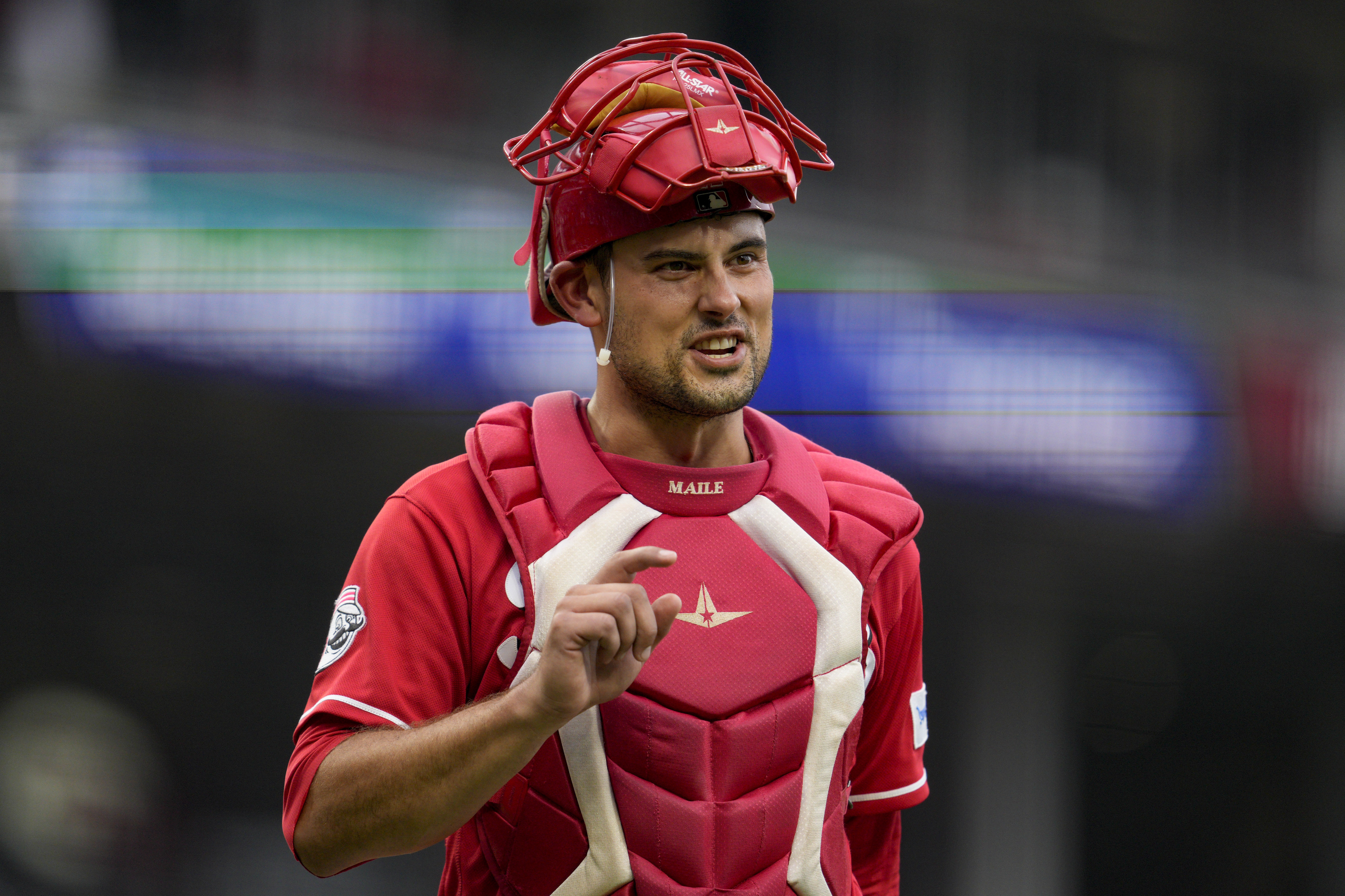 FILE -Cincinnati Reds catcher Luke Maile gestures during a baseball game against the Cleveland Guardians in Cincinnati, Wednesday, Aug. 16, 2023. Catcher Luke Maile is guaranteed $3.5 million under his one-year contract with the Cincinnati Reds, which prevented him from becoming a free agent after the World Series.