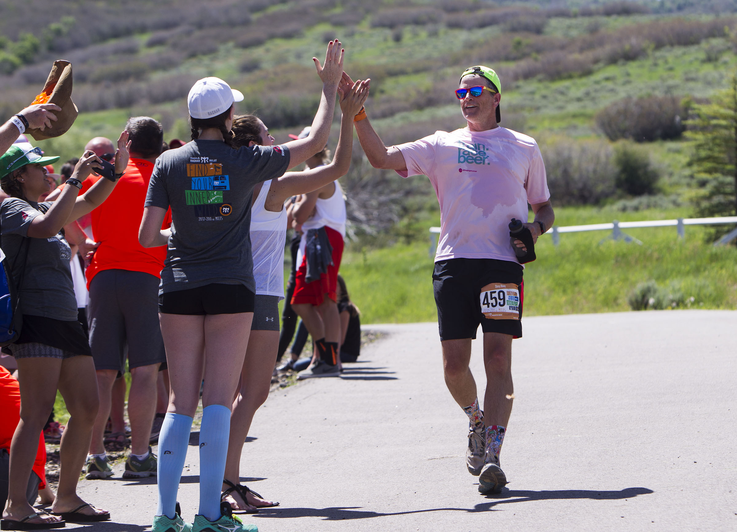 Tyler Fikes high-fives his team, "Bro Crew 72," at the finish line of the 2017 Ragnar Race in Midway on June 3, 2017. Ragnar Events announced Wednesday that it is bringing back its full Wasatch Back race next year for the first time since 2019.