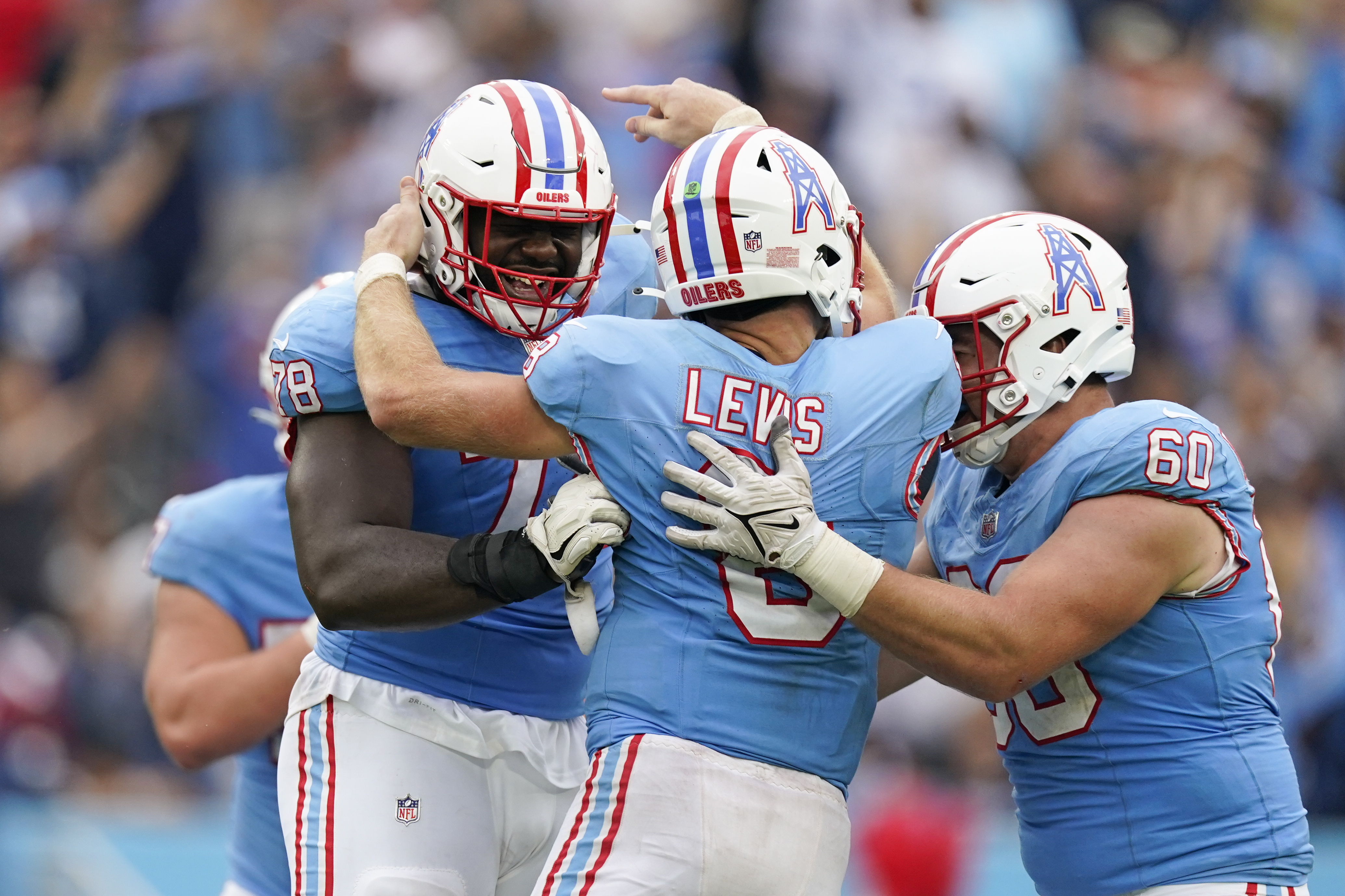 Tennessee Titans quarterback Will Levis (8) celebrates with Tennessee Titans offensive tackles Nicholas Petit-Frere (78) and Daniel Brunskill (60) after throwing a touchdown pass against the Atlanta Falcons during the second half of an NFL football game, Sunday, Oct. 29, 2023, in Nashville, Tenn. 