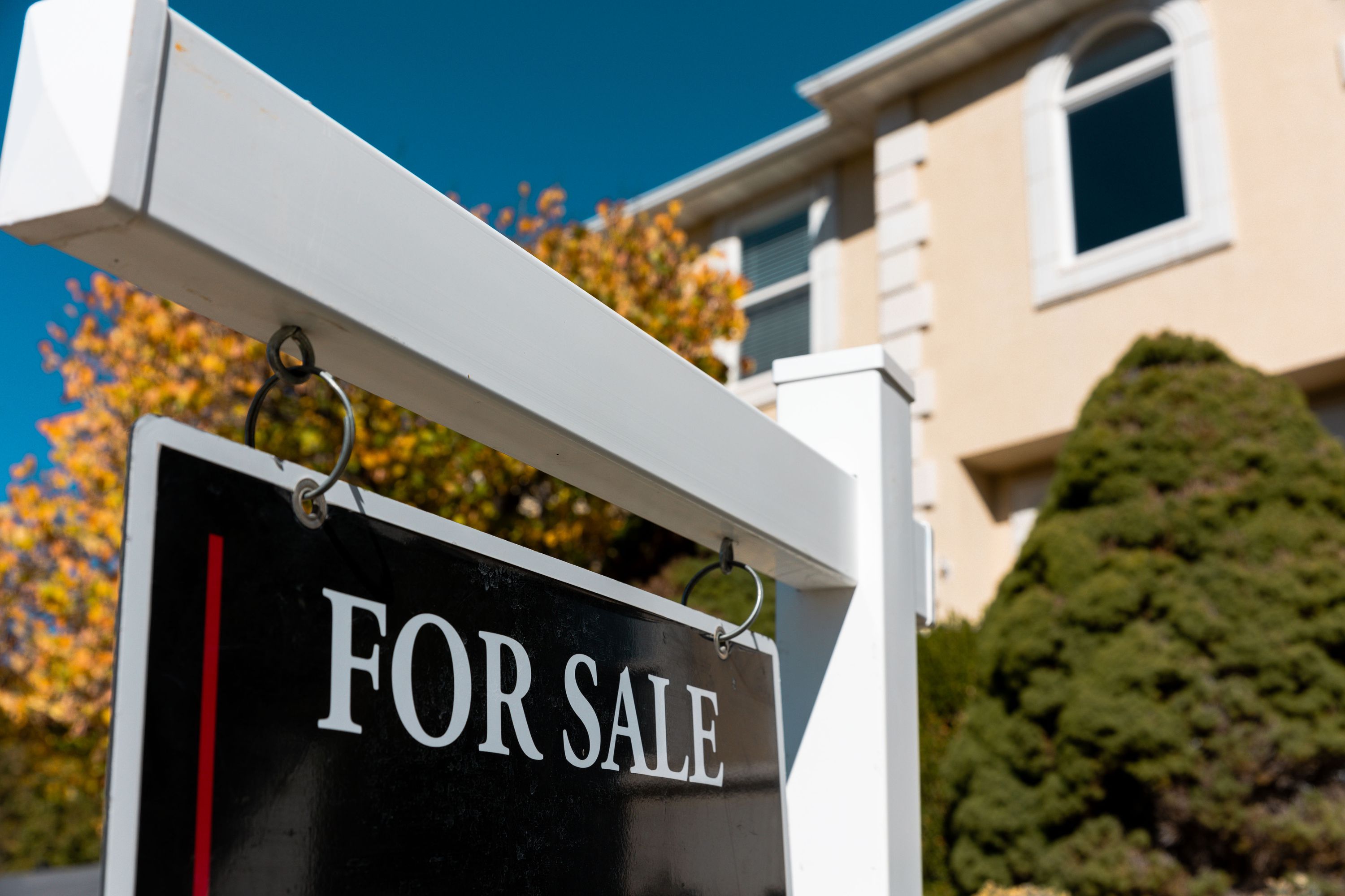 A “for sale” sign in front of a home in North Salt Lake on Monday. The National Association of Realtors and two codefendants were ordered to pay nearly $1.8 billion in damages to about half a million home sellers.