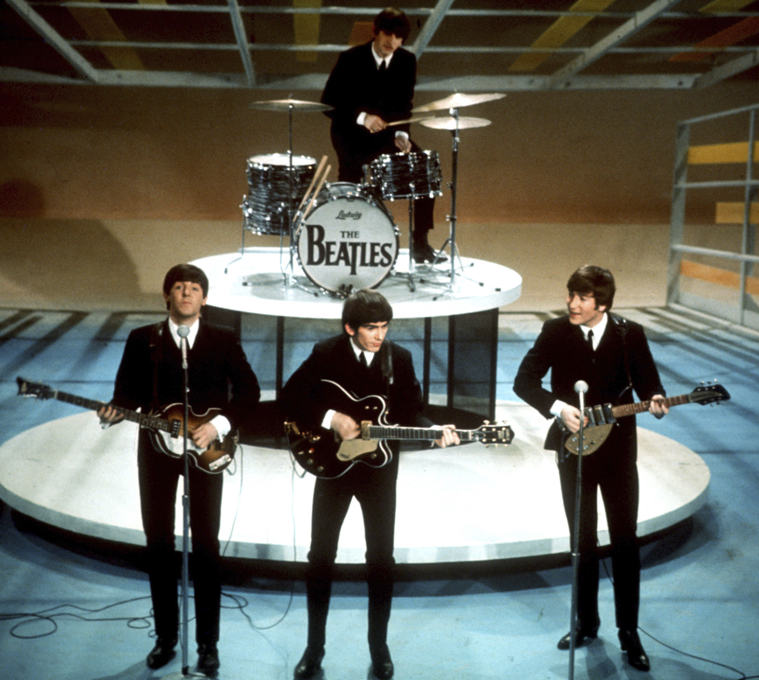 The Beatles, foreground from left, Paul McCartney, George Harrison, John Lennon and Ringo Starr on drums perform on the CBS "Ed Sullivan Show" in New York on Feb. 9, 1964. A new song is being released Thursday.