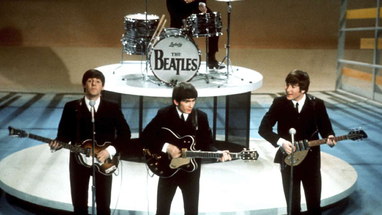 The Beatles, foreground from left, Paul McCartney, George Harrison, John Lennon and Ringo Starr on drums perform on the CBS "Ed Sullivan Show" in New York on Feb. 9, 1964. A new song is being released Thursday.