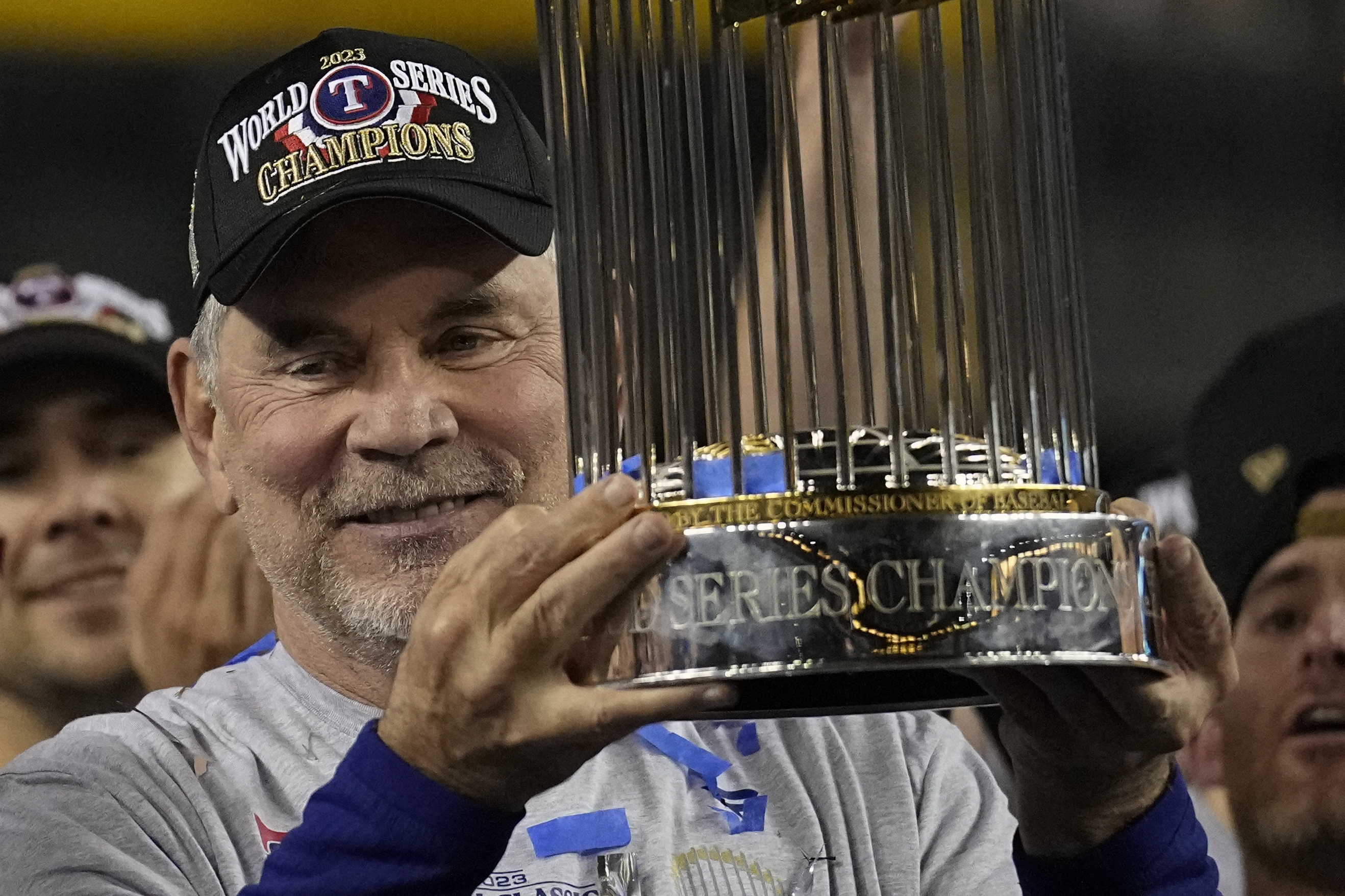 Texas Rangers manager Bruce Bochy celebrates with the trophy after winning Game 5 of the baseball World Series against the Arizona Diamondbacks Wednesday, Nov. 1, 2023, in Phoenix. The Rangers won 5-0 to win the series 4-1. 