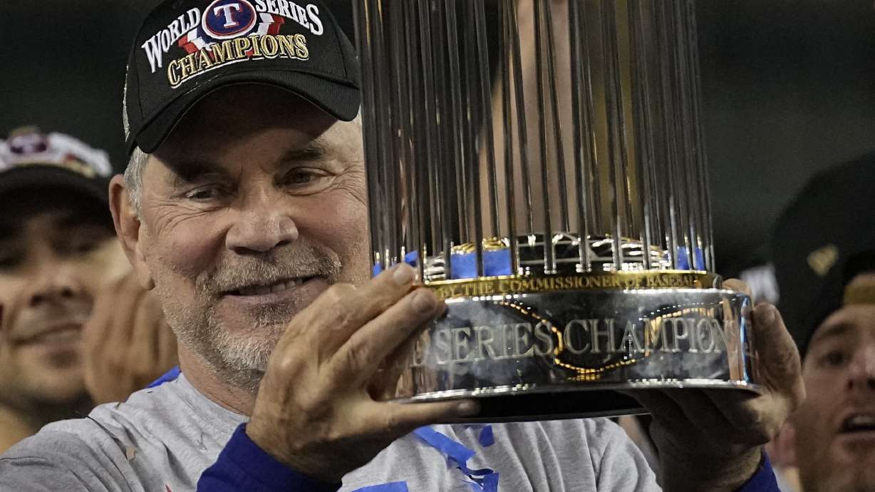 Texas Rangers manager Bruce Bochy celebrates with the trophy after winning Game 5 of the baseball World Series against the Arizona Diamondbacks Wednesday, Nov. 1, 2023, in Phoenix. The Rangers won 5-0 to win the series 4-1.