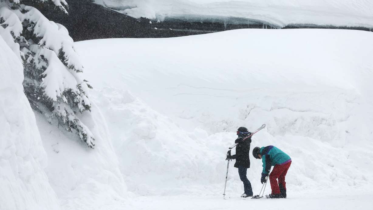 Skiers walk to their lodging at Solitude Mountain Resort in Big Cottonwood Canyon on April 4. Resort officials released details on the resort's new parking reservation system on Thursday.