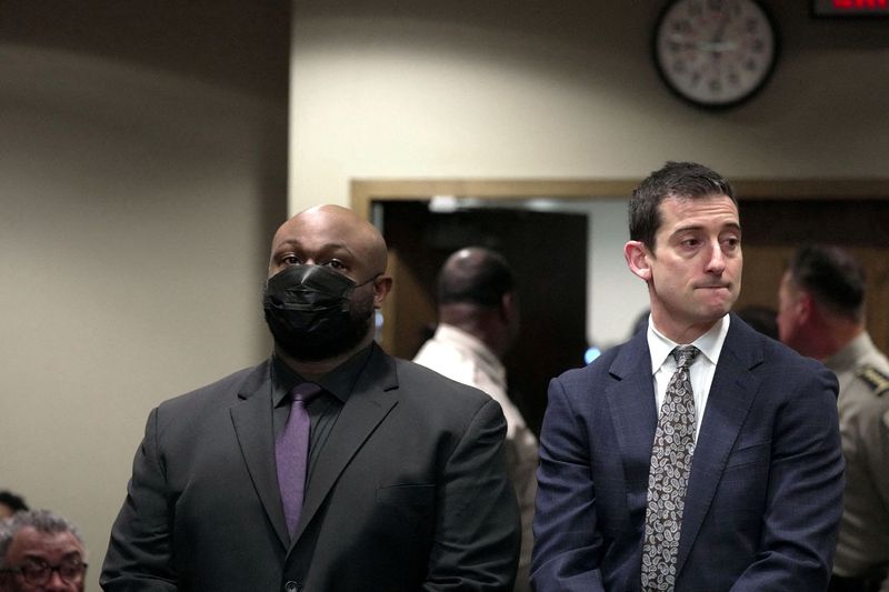 Desmond Mills Jr. with attorney Blake Ballin stand as five former Memphis police officers who have been charged in the fatal beating of Tyre Nichols attend a hearing at Shelby County courthouse in Memphis, Tennessee, Feb. 17.