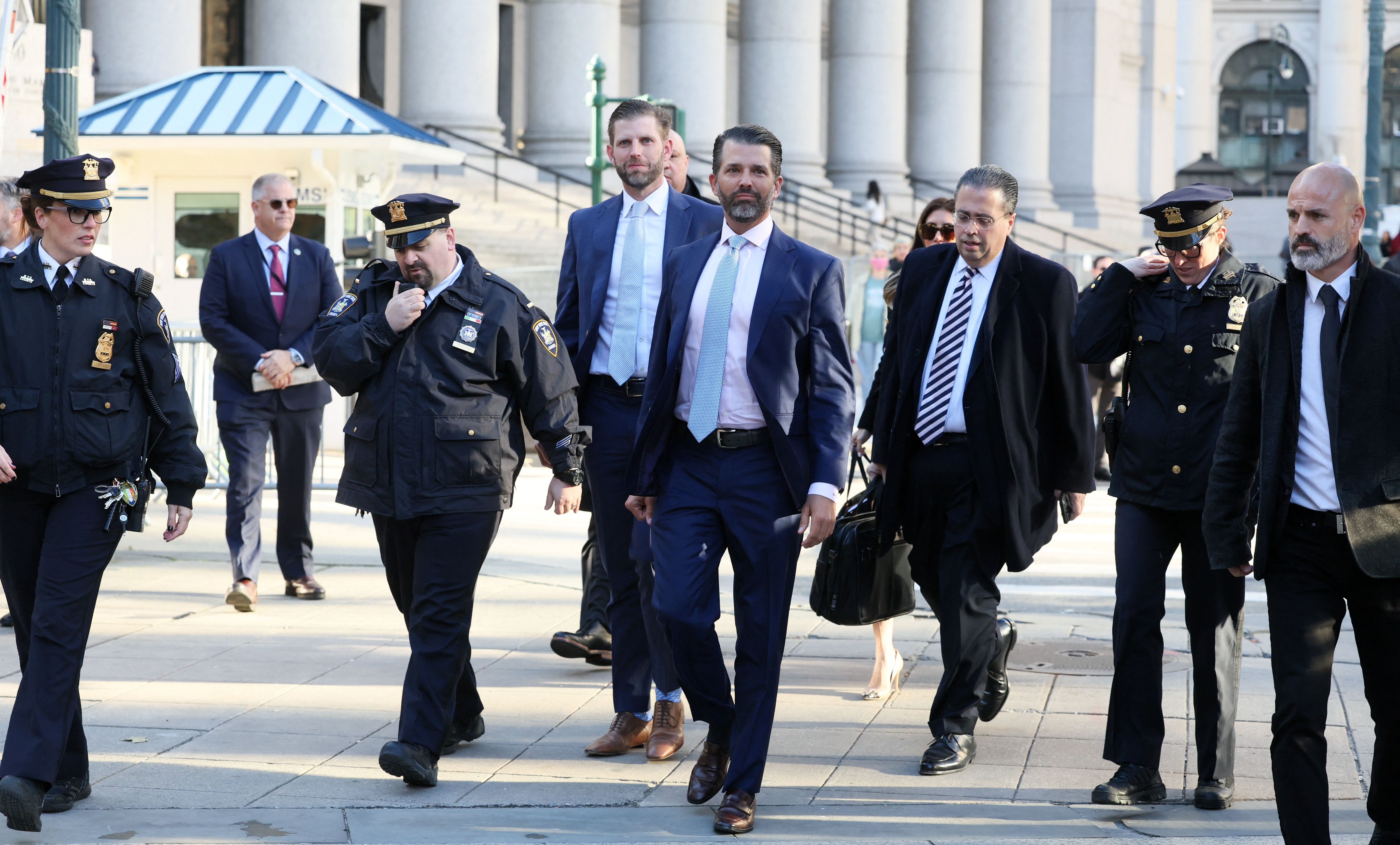 Former U.S. President Donald Trump's sons and co-defendants Donald Trump Jr., and Eric Trump walk to attend the Trump Organization civil fraud trial, in New York State Supreme Court in New York City, Thursday.