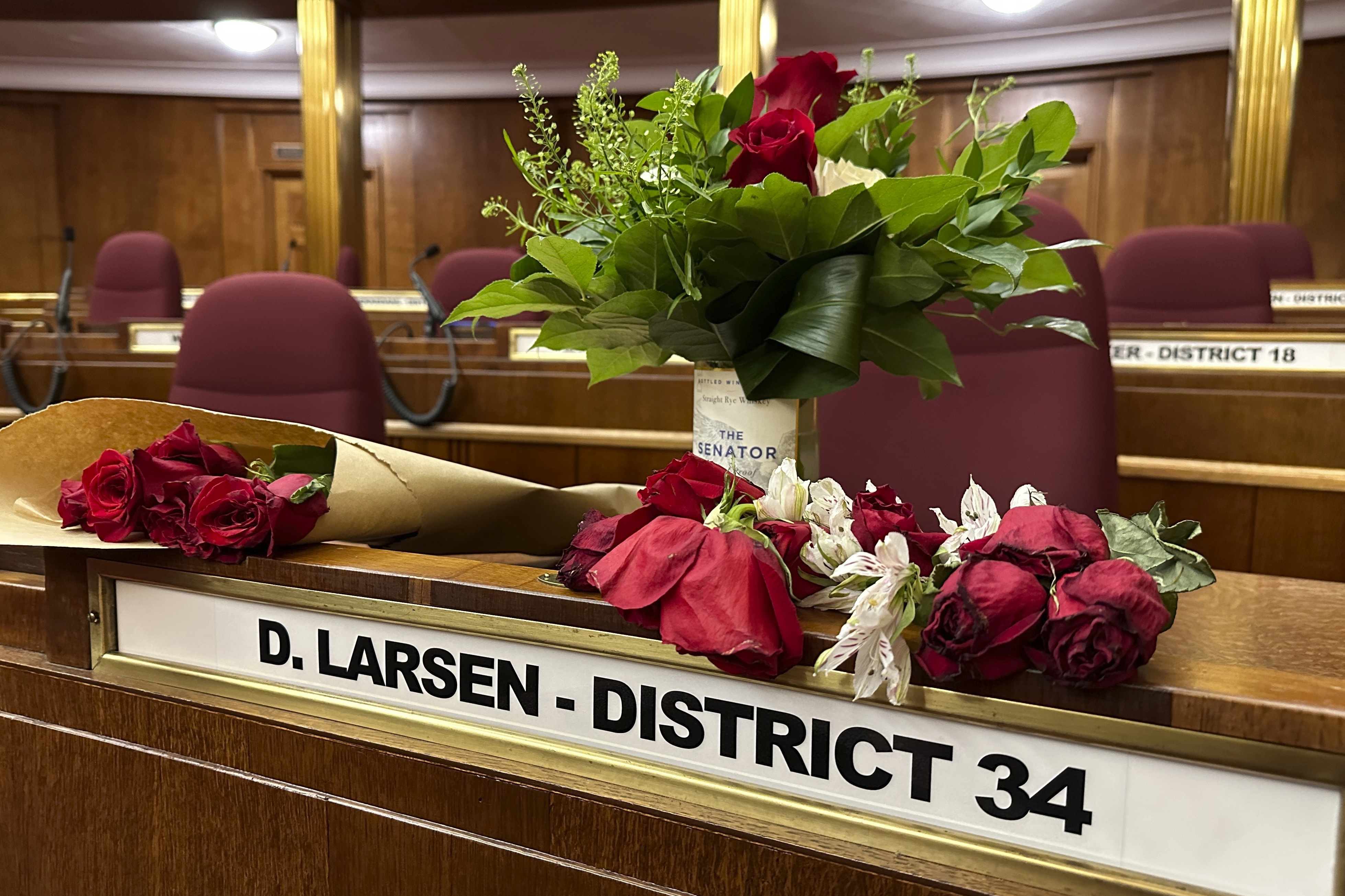 Flowers sit on the Senate desk of late North Dakota Sen. Doug Larsen, Oct. 6, inside the state Capitol in Bismarck, N.D. Larsen and his family died on Oct. 1, in a plane crash near Moab.