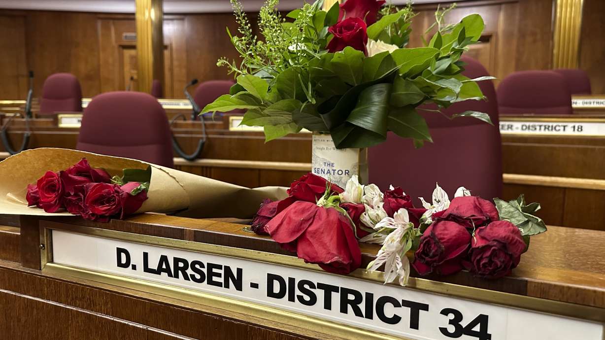 Flowers sit on the Senate desk of late North Dakota Sen. Doug Larsen, Oct. 6, inside the state Capitol in Bismarck, N.D. Larsen and his family died on Oct. 1, in a plane crash near Moab.