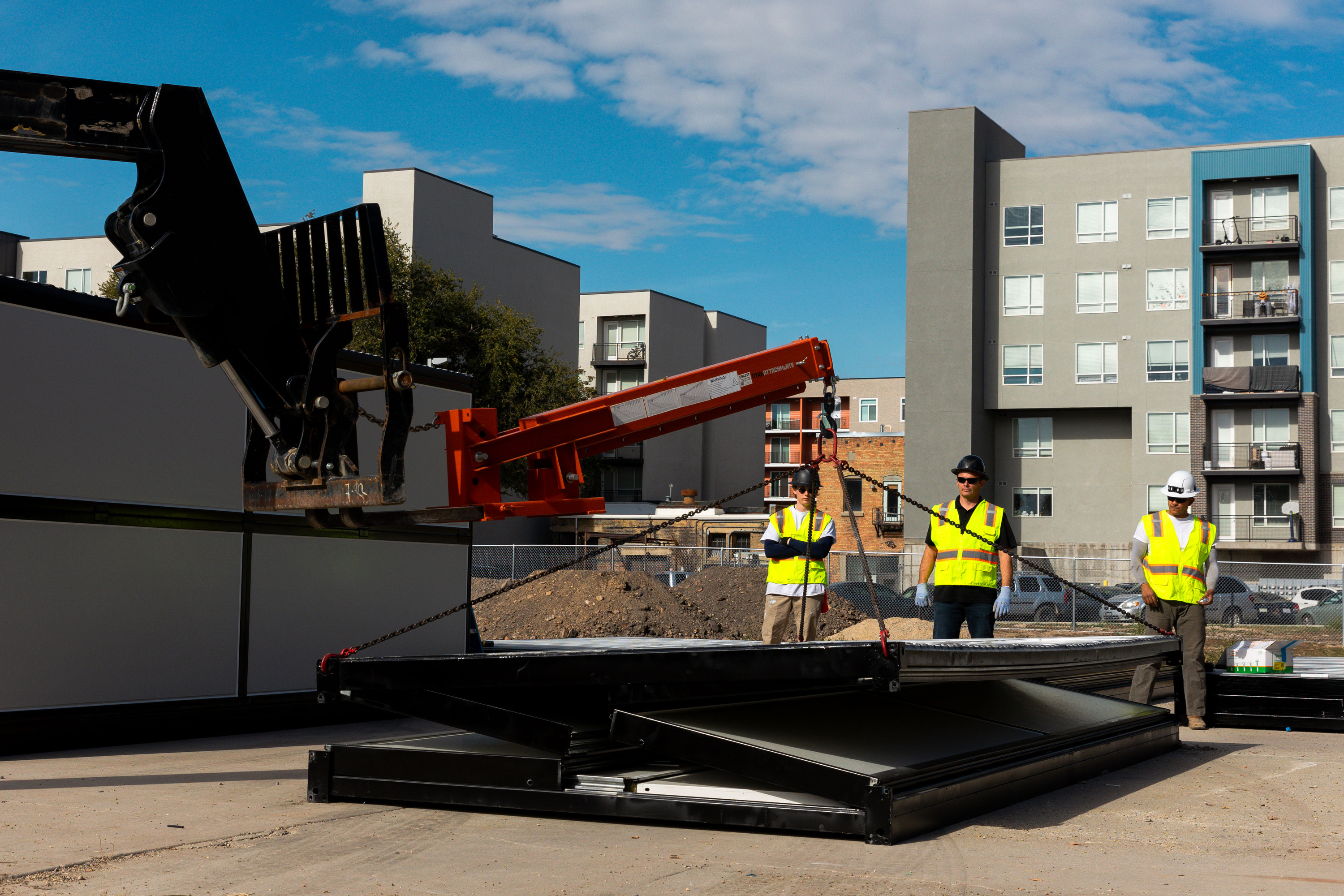 Foldum construction members demonstrate the setup of a microshelter community housing unit at a site near 300 South and 600 West in Salt Lake City on Thursday. The units are quickly transformed into small shelters.