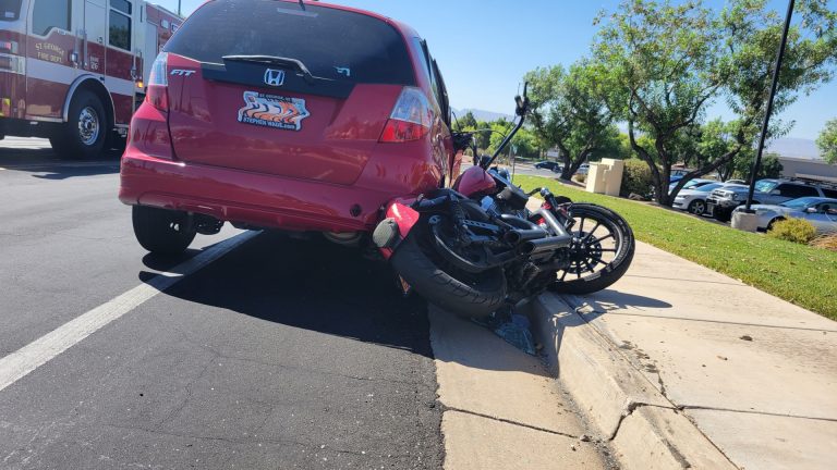 A Harley-Davidson is partially crushed under a Honda Fit after a crash at the corner of Red Hills Drive and 2450 East in St. George, July 19. The Honda's driver has been sentenced.