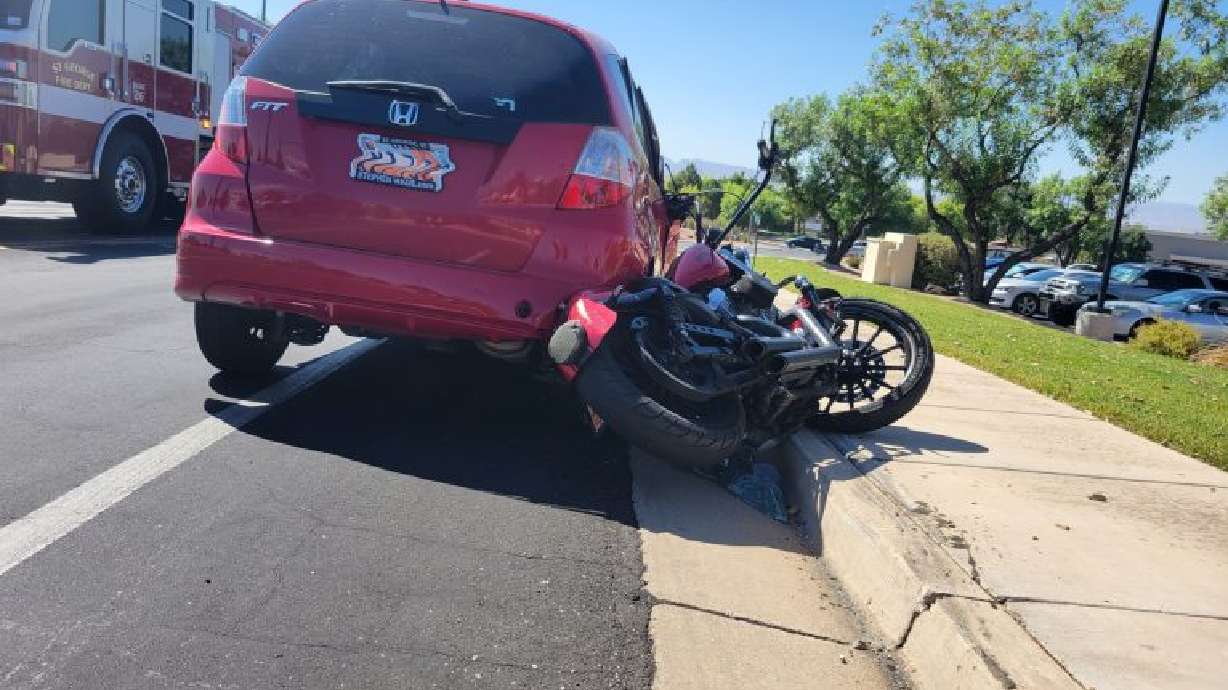A Harley-Davidson is partially crushed under a Honda Fit after a crash at the corner of Red Hills Drive and 2450 East in St. George, July 19. The Honda's driver has been sentenced.