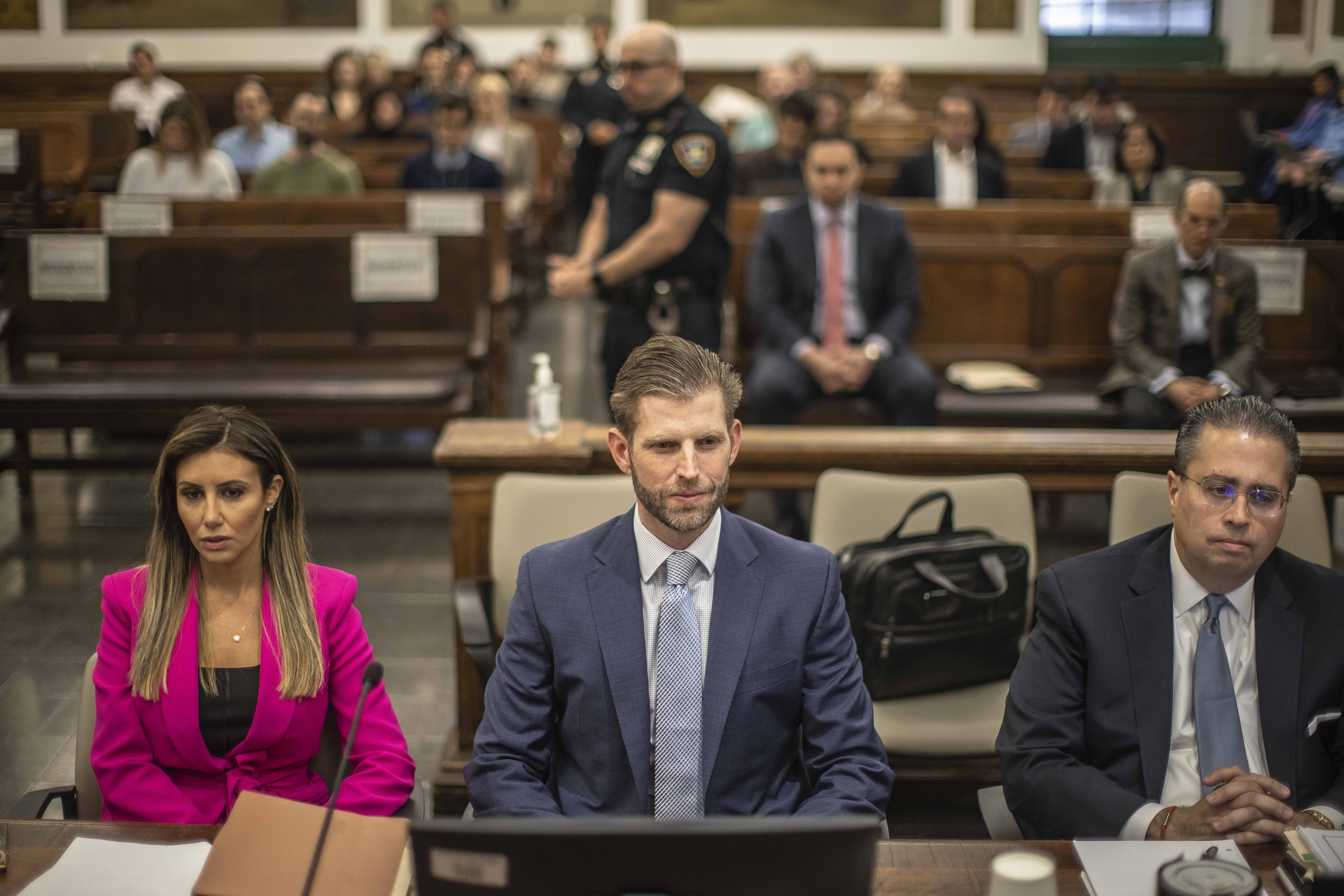 Eric Trump, son of former President Donald Trump, center, is seated ahead of his second day of testimony at New York State Supreme Court, Friday, in New York.
