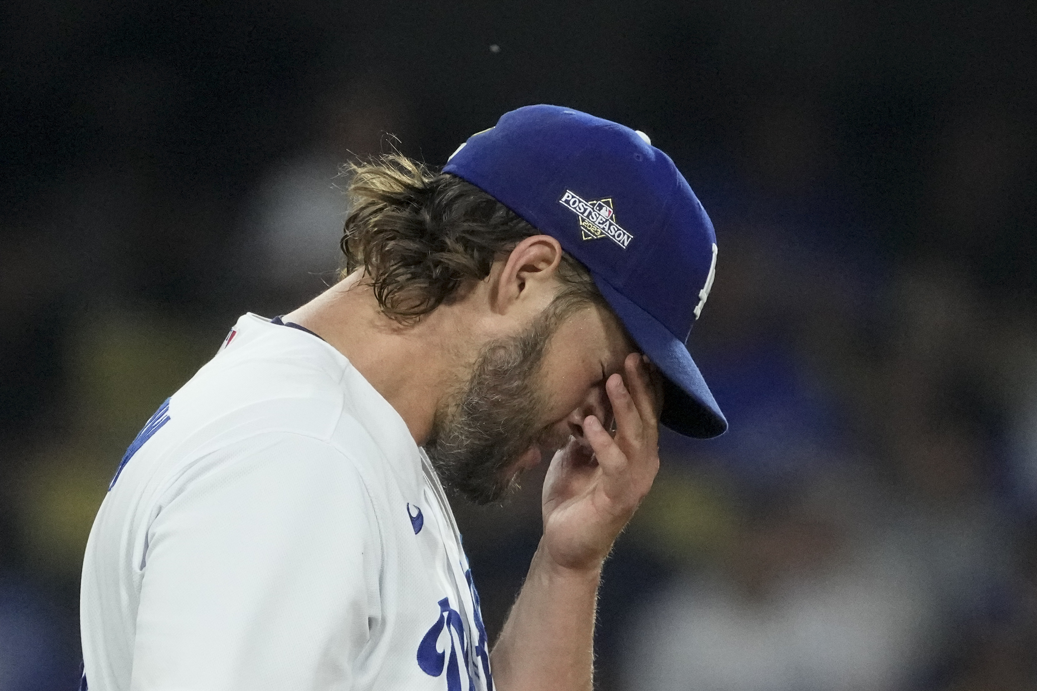 Los Angeles Dodgers starting pitcher Clayton Kershaw rubs his face after Arizona Diamondbacks' Alek Thomas scored off an RBI double by Evan Longoria during the first inning in Game 1 of a baseball NL Division Series Saturday, Oct. 7, 2023, in Los Angeles. 
