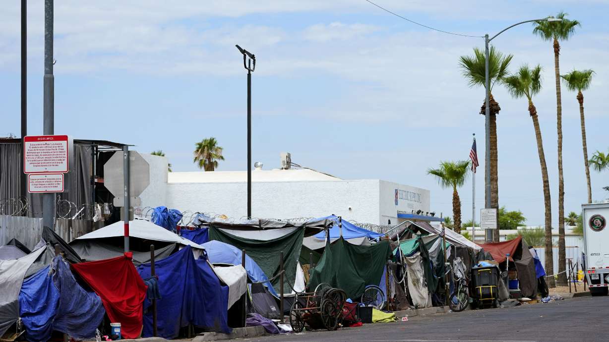 Tents line the street of "The Zone," a homeless encampment, July 11, 2023, in Phoenix. The City of Phoenix said it has successfully cleared out a massive downtown homeless encampment by the Saturday, court-ordered deadline by helping more than 500 people find beds in shelters and motels.